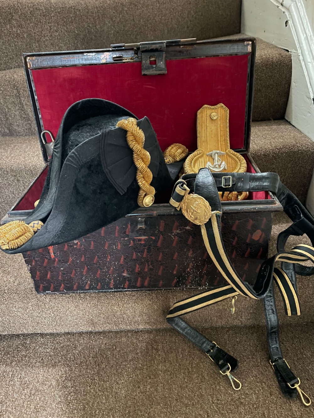 Early C20th British Royal Naval officer’s ceremonial dress bicorn hat , gold braided epaulettes and sword belt by Gieves, London.