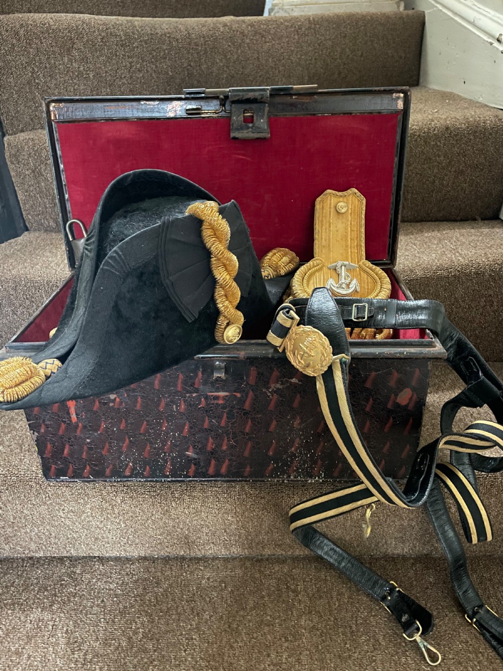 Early C20th British Royal Naval officer’s ceremonial dress bicorn hat , gold braided epaulettes and sword belt by Gieves, London. View V