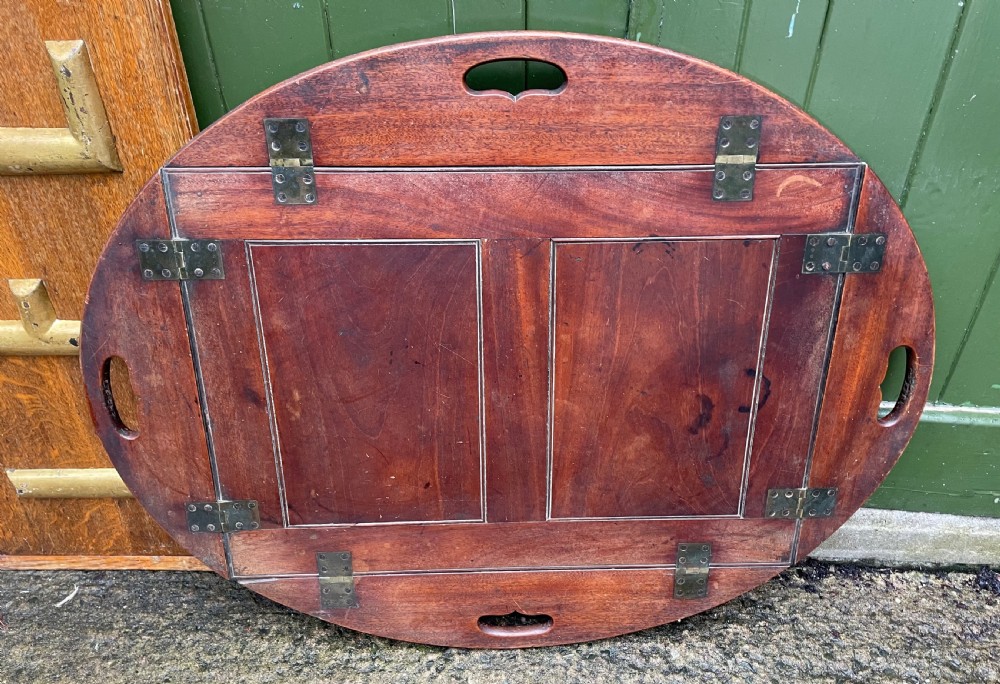 Late C18th George III period mahogany oval ‘butler’s’ tray with brass hinged folding sides . View II
