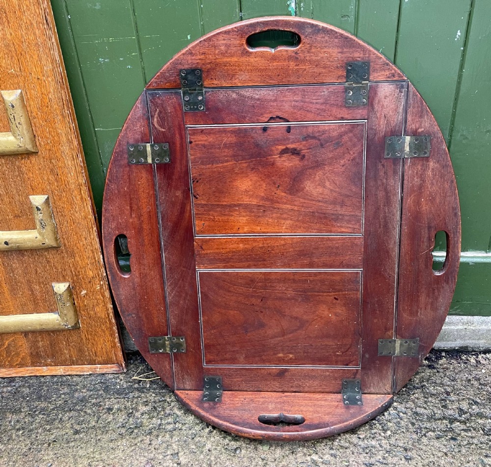 Late C18th George III period mahogany oval ‘butler’s’ tray with brass hinged folding sides . View V