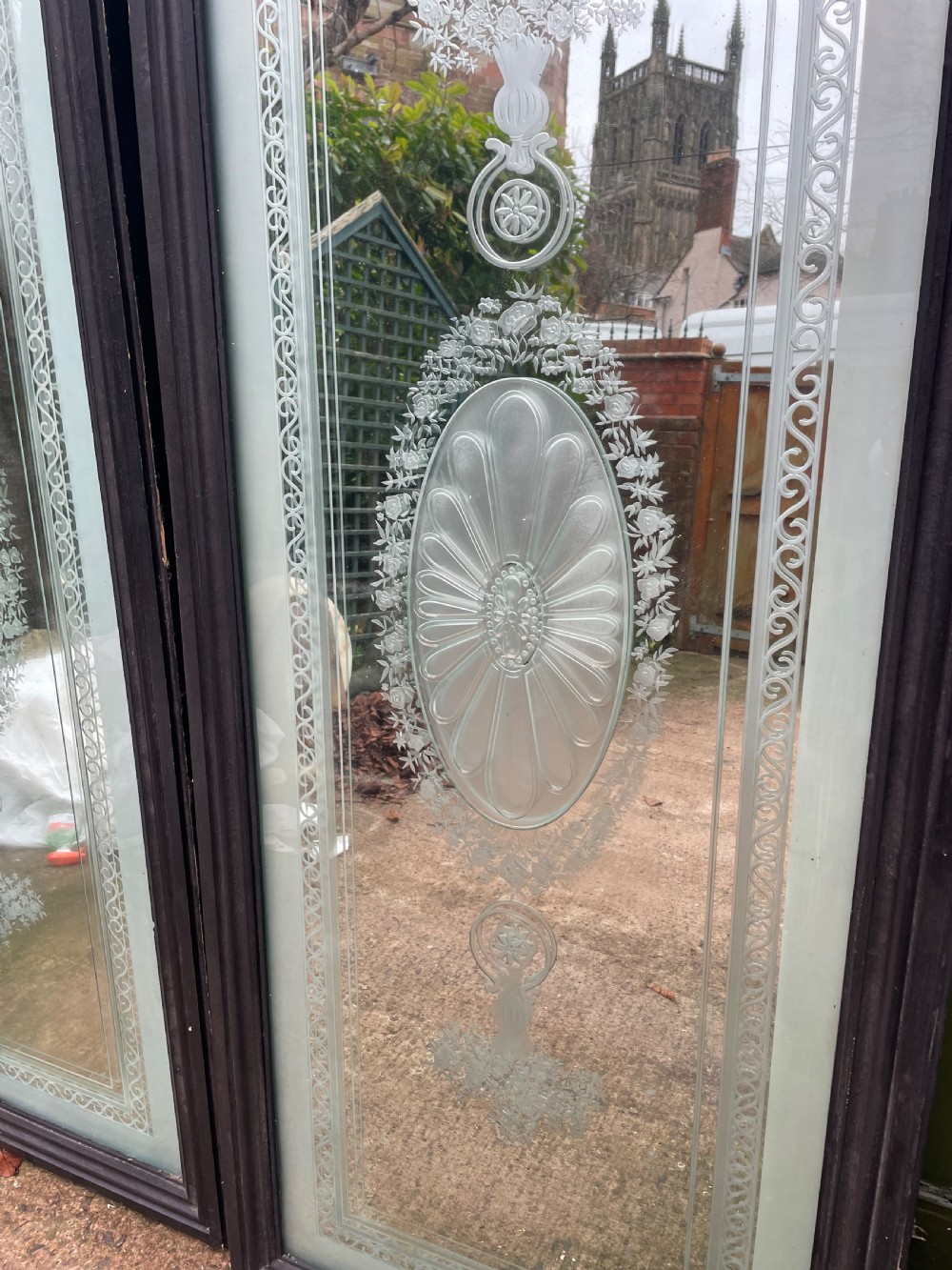 A pair of tall rectangular Edwardian wall mirrors featuring detailed etched floral urns and central oval medallions in dark wooden frames. View II