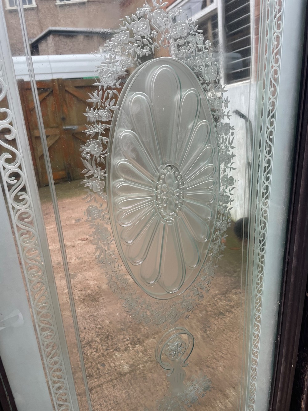 A pair of tall rectangular Edwardian wall mirrors featuring detailed etched floral urns and central oval medallions in dark wooden frames. View IX