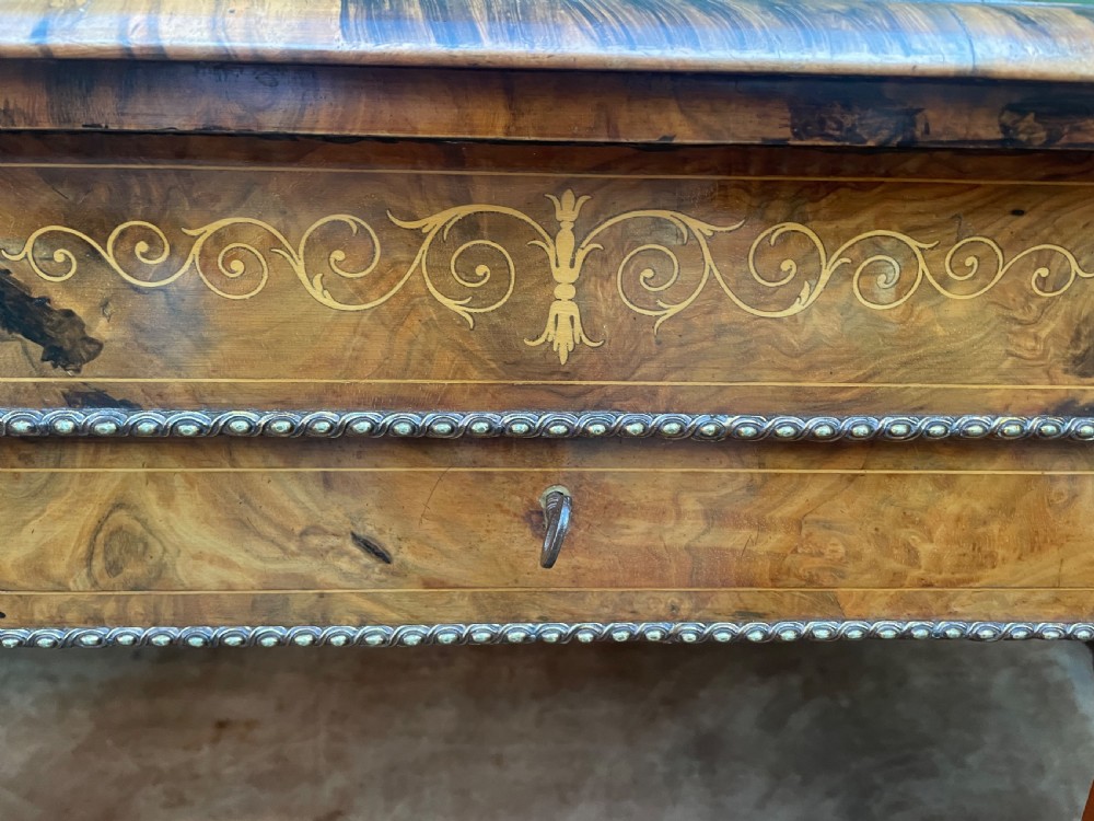 A mid-19th century Victorian burr walnut credenza featuring boxwood marquetry inlay, gilded ormolu mounts, a central drawer, and curved glass side display doors. View XIV