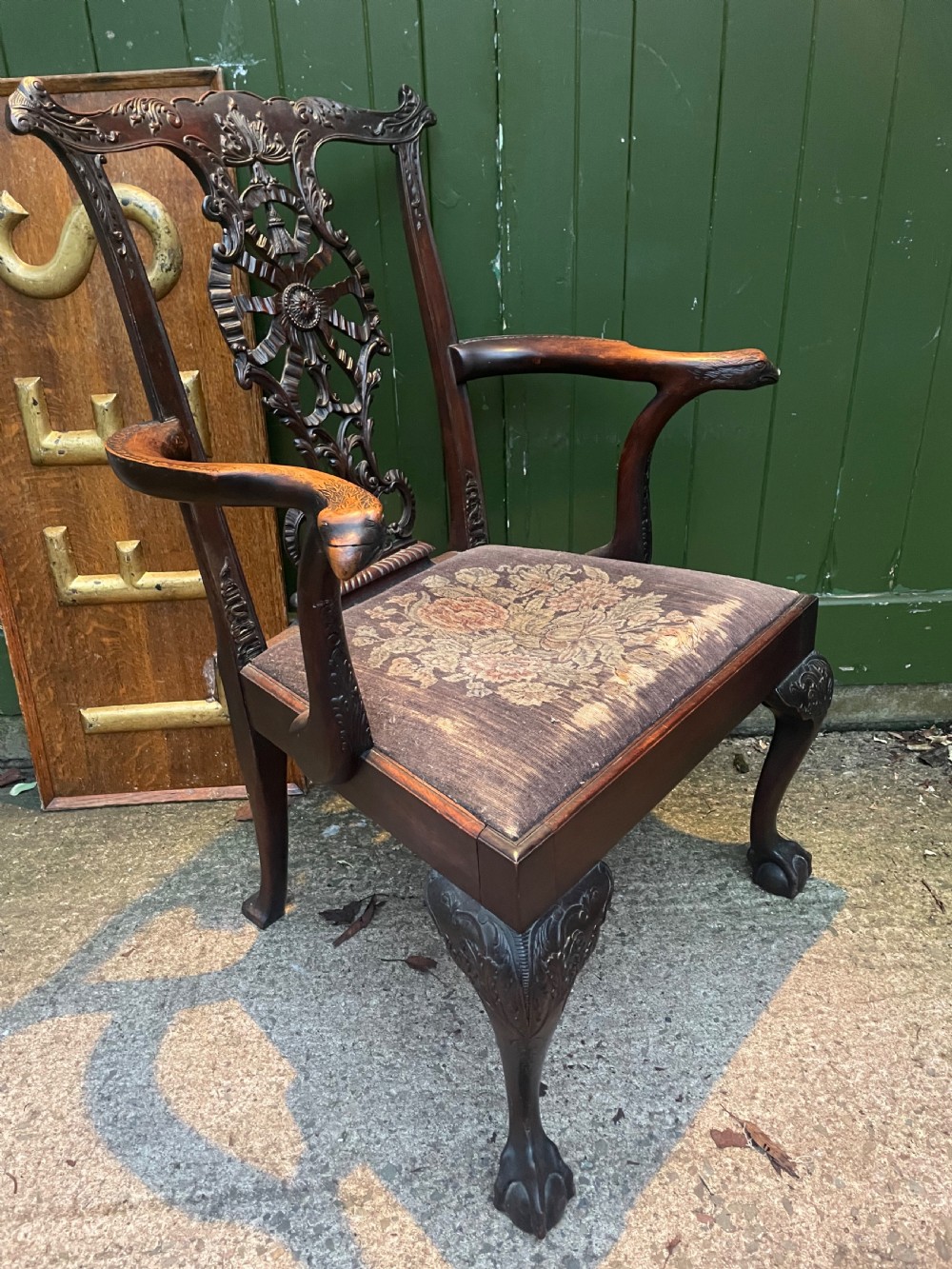 A late 19th-century carved mahogany armchair featuring carved eagle-head armrests, a pierced ribbon splat back, floral tapestry upholstery, and cabriole legs with claw-and-ball feet. View X