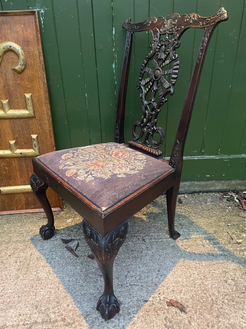 A late 19th-century carved mahogany armchair featuring carved eagle-head armrests, a pierced ribbon splat back, floral tapestry upholstery, and cabriole legs with claw-and-ball feet. View XIV