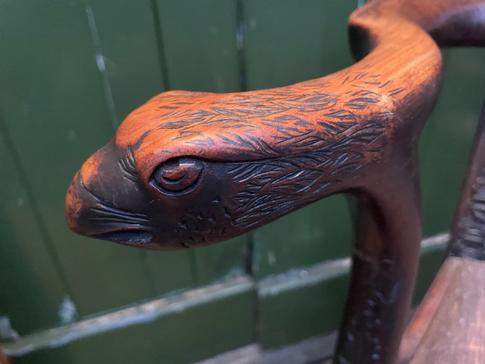 A late 19th-century carved mahogany armchair featuring carved eagle-head armrests, a pierced ribbon splat back, floral tapestry upholstery, and cabriole legs with claw-and-ball feet. View XVII