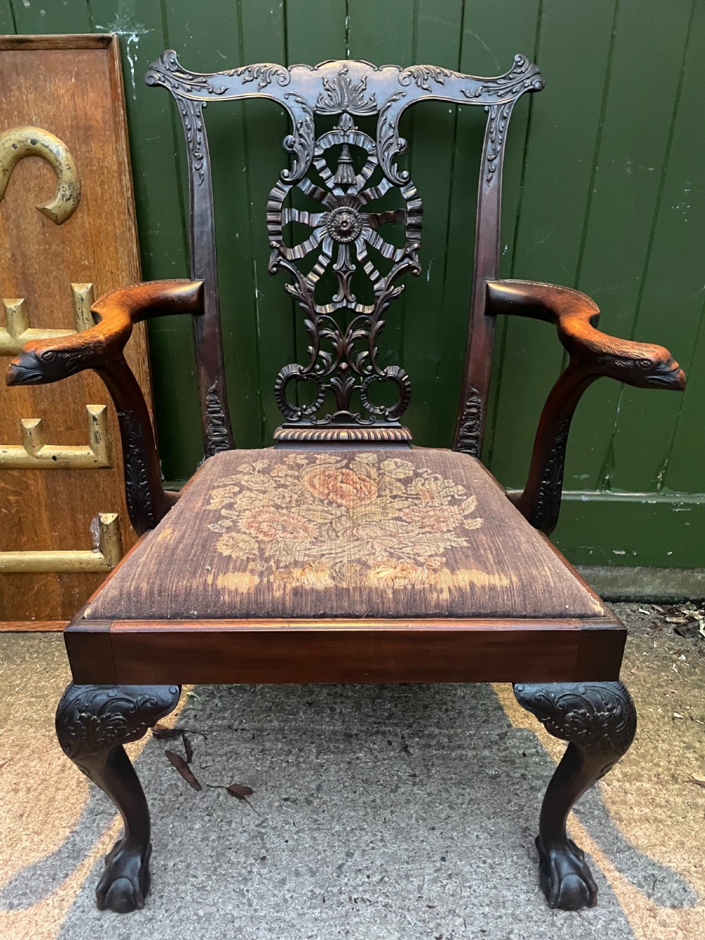 A late 19th-century carved mahogany armchair featuring carved eagle-head armrests, a pierced ribbon splat back, floral tapestry upholstery, and cabriole legs with claw-and-ball feet. View XVIII