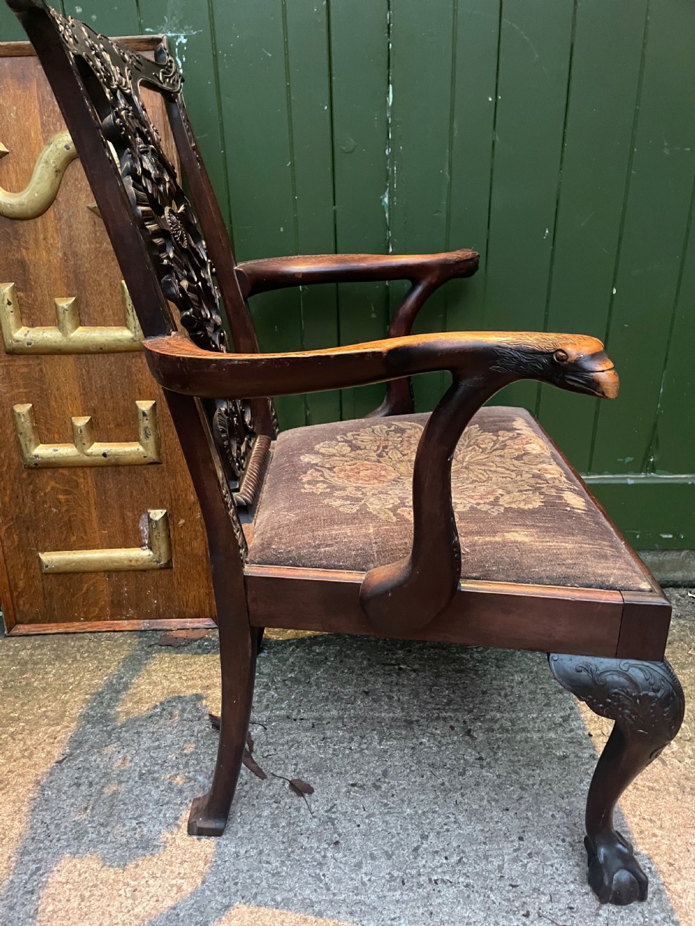 A late 19th-century carved mahogany armchair featuring carved eagle-head armrests, a pierced ribbon splat back, floral tapestry upholstery, and cabriole legs with claw-and-ball feet. View XIX