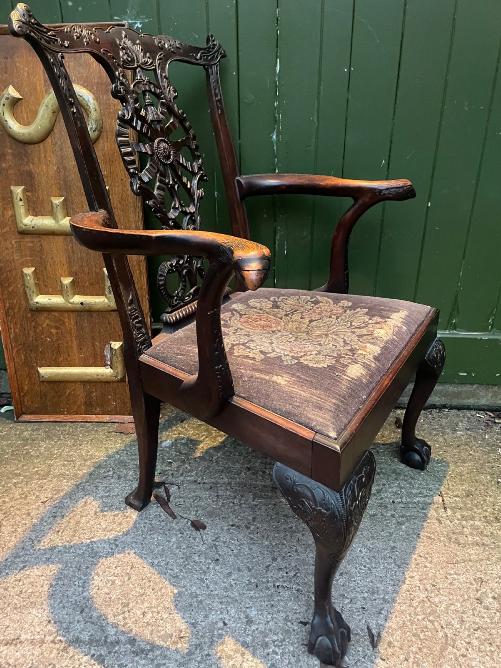 A late 19th-century carved mahogany armchair featuring carved eagle-head armrests, a pierced ribbon splat back, floral tapestry upholstery, and cabriole legs with claw-and-ball feet. View XXI