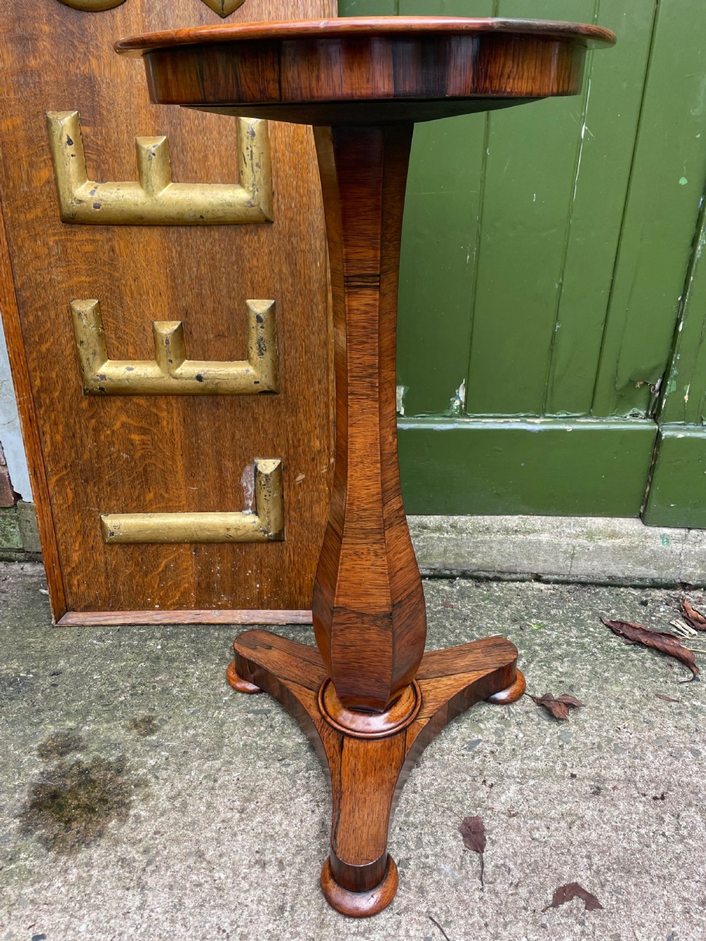 An early 19th-century George IV occasional table featuring a circular top with an inset marble panel, a faceted rosewood column, and a triform base. View IV