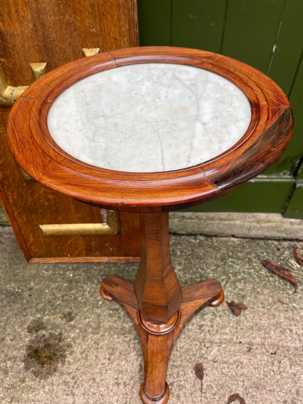 An early 19th-century George IV occasional table featuring a circular top with an inset marble panel, a faceted rosewood column, and a triform base. View VI