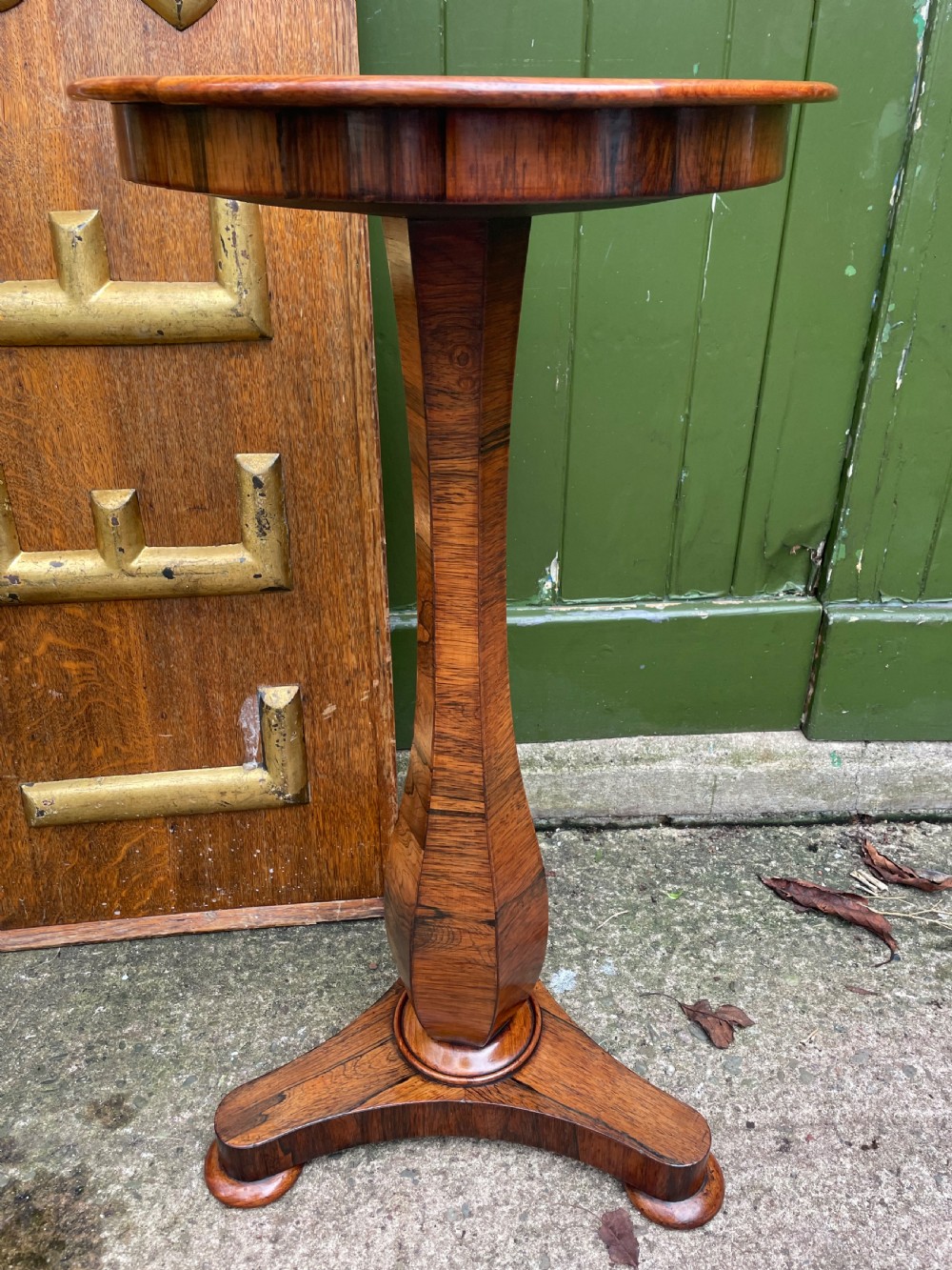 An early 19th-century George IV occasional table featuring a circular top with an inset marble panel, a faceted rosewood column, and a triform base. View VII