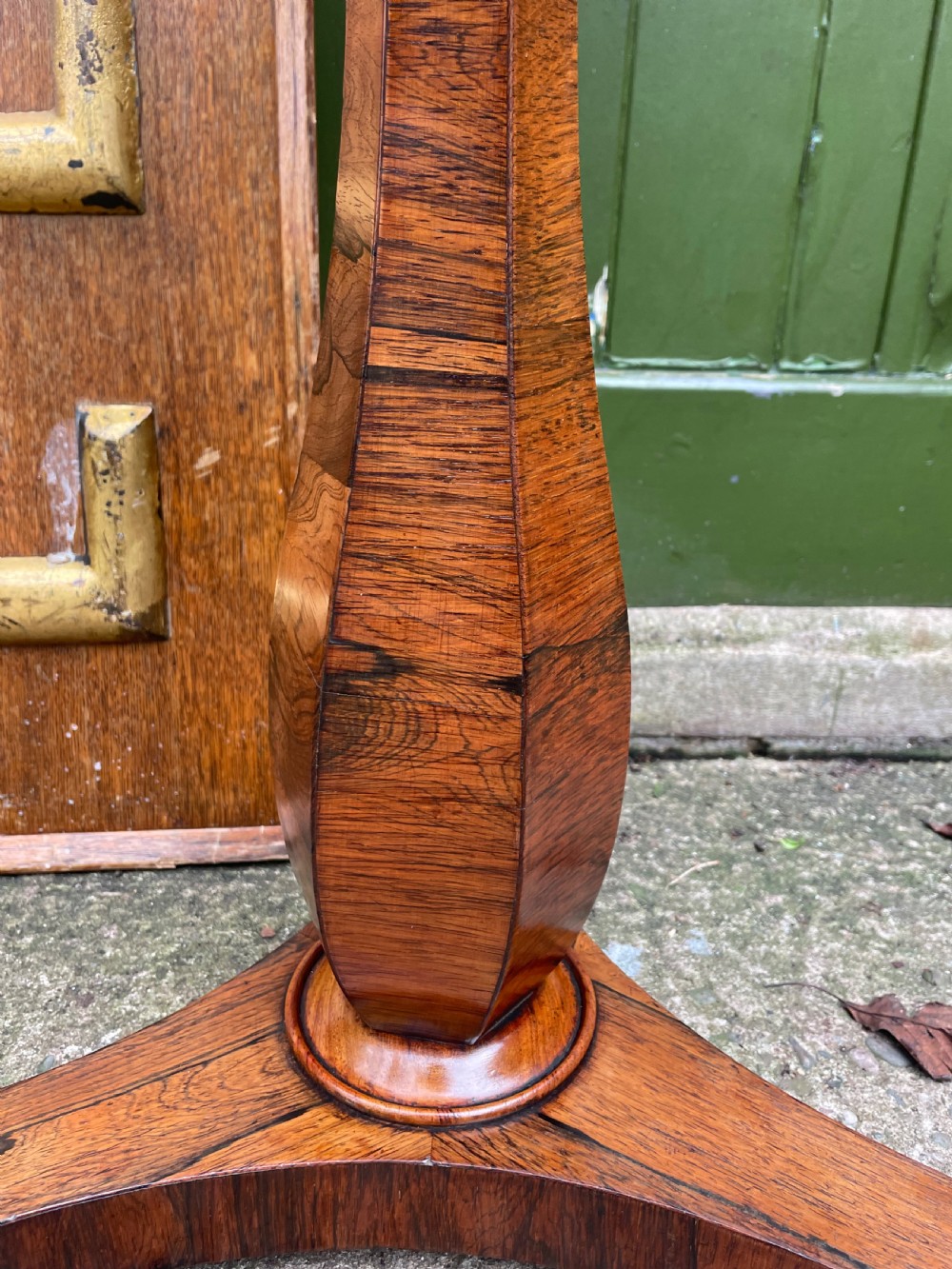 An early 19th-century George IV occasional table featuring a circular top with an inset marble panel, a faceted rosewood column, and a triform base. View VIII