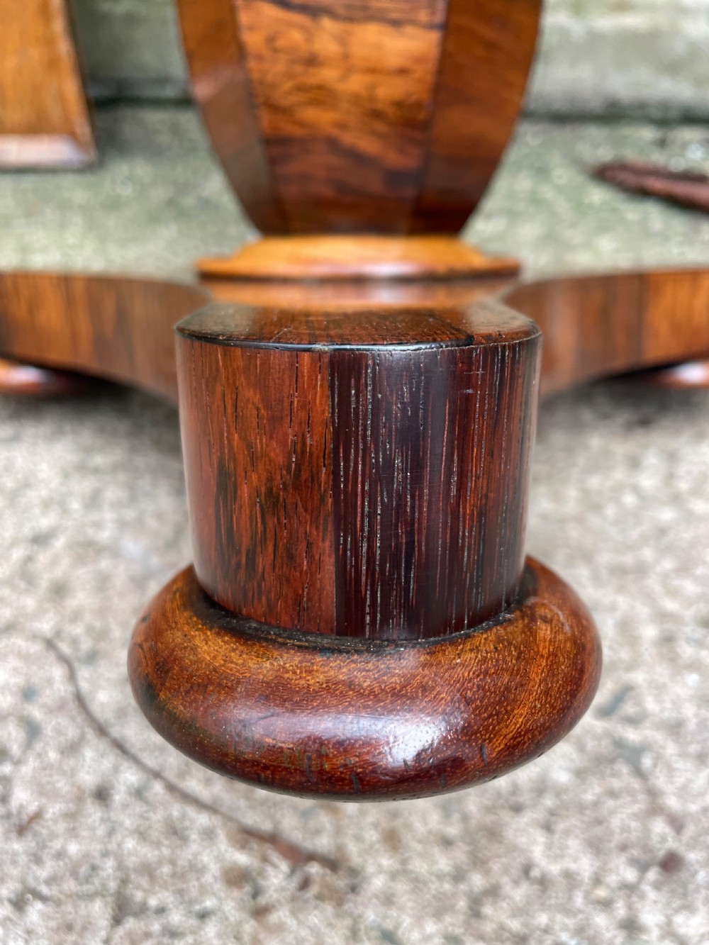 An early 19th-century George IV occasional table featuring a circular top with an inset marble panel, a faceted rosewood column, and a triform base. View IX