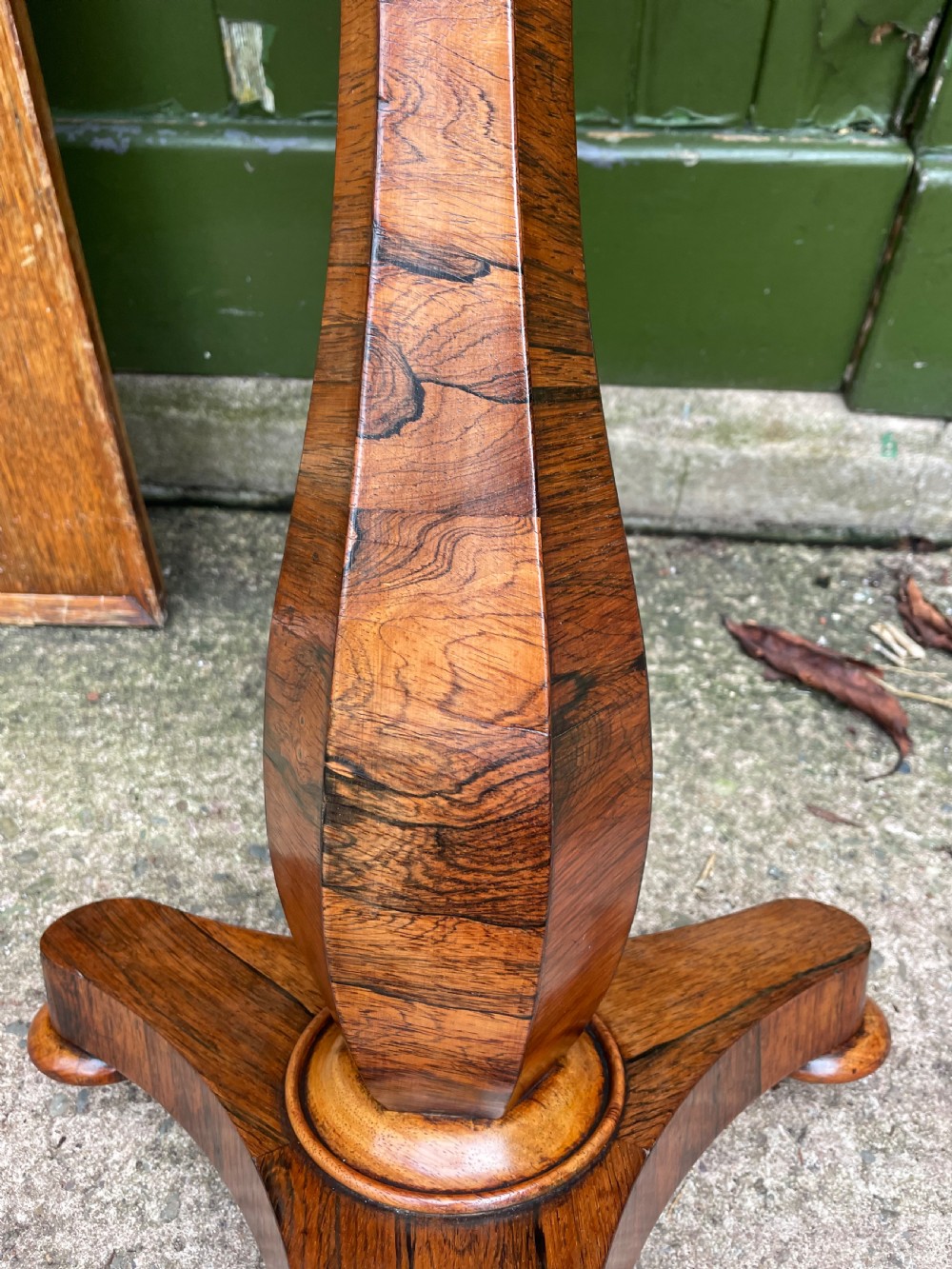 An early 19th-century George IV occasional table featuring a circular top with an inset marble panel, a faceted rosewood column, and a triform base. View X