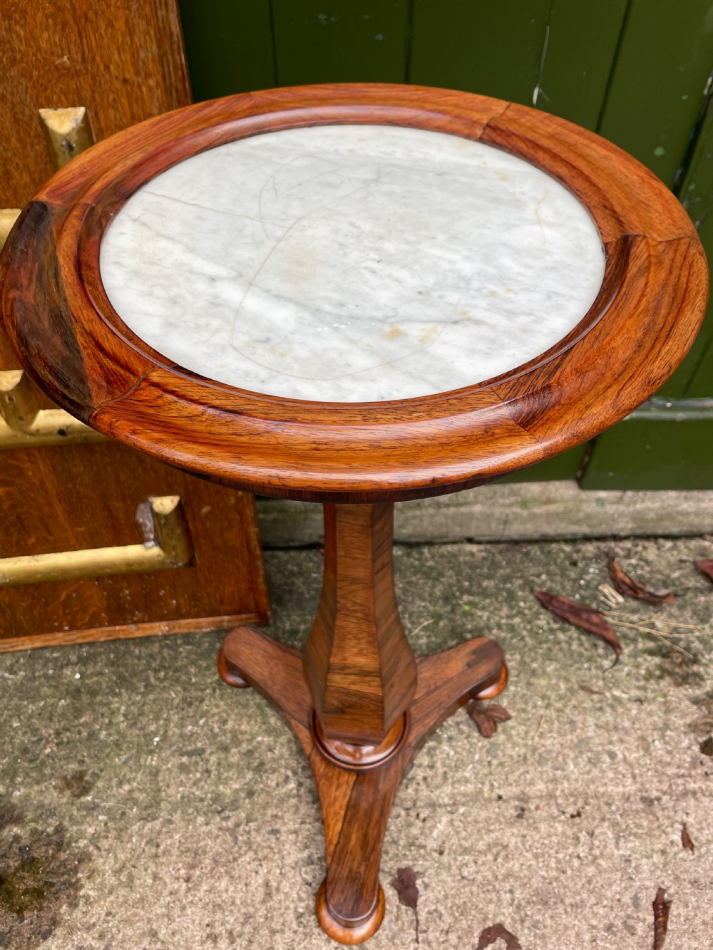 An early 19th-century George IV occasional table featuring a circular top with an inset marble panel, a faceted rosewood column, and a triform base. View XIV