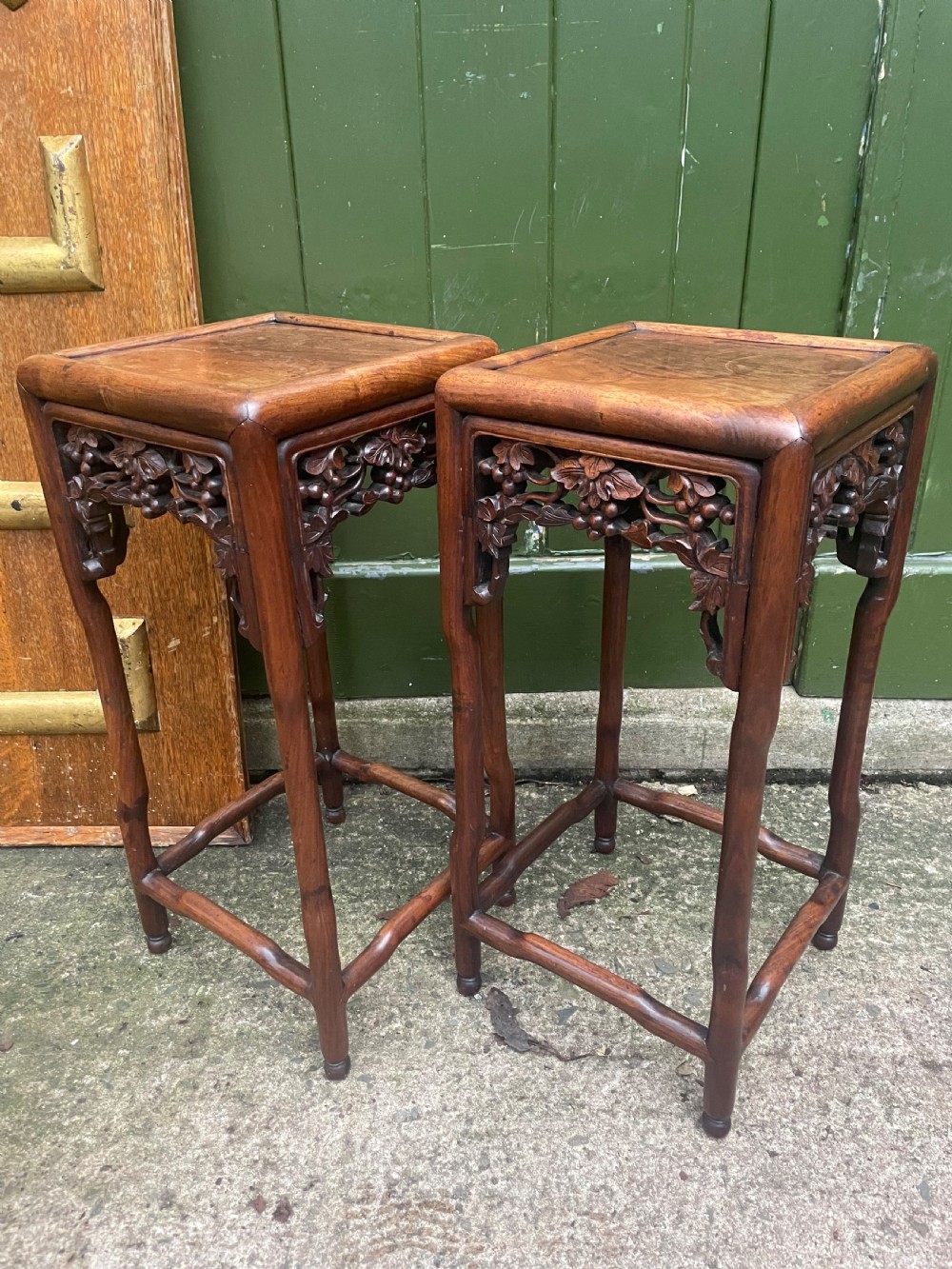 A pair of late nineteenth to early twentieth century Chinese Qing Dynasty carved huali hardwood side tables featuring openwork grapevine aprons and organic faux-bamboo legs. View III