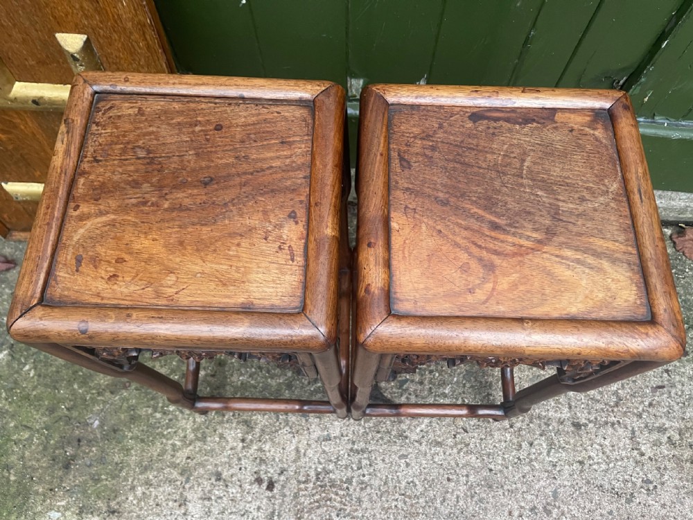 A pair of late nineteenth to early twentieth century Chinese Qing Dynasty carved huali hardwood side tables featuring openwork grapevine aprons and organic faux-bamboo legs. View V