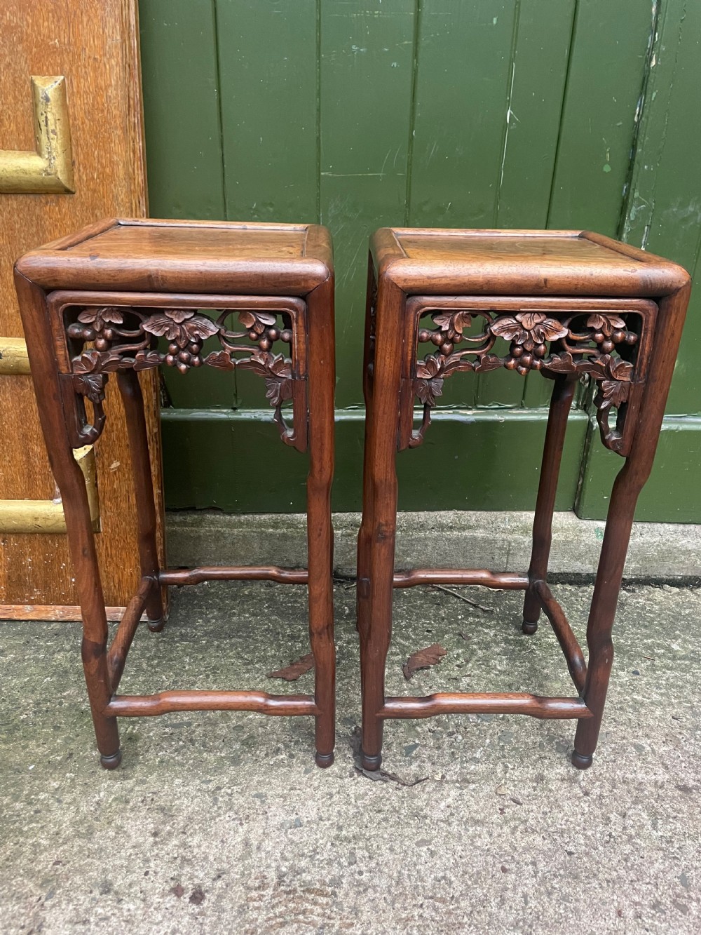 A pair of late nineteenth to early twentieth century Chinese Qing Dynasty carved huali hardwood side tables featuring openwork grapevine aprons and organic faux-bamboo legs. View VI