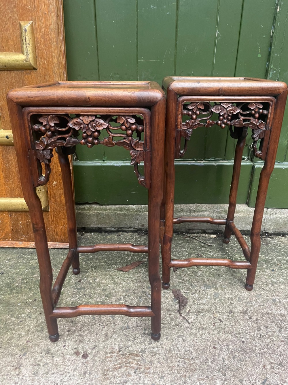 A pair of late nineteenth to early twentieth century Chinese Qing Dynasty carved huali hardwood side tables featuring openwork grapevine aprons and organic faux-bamboo legs. View IX