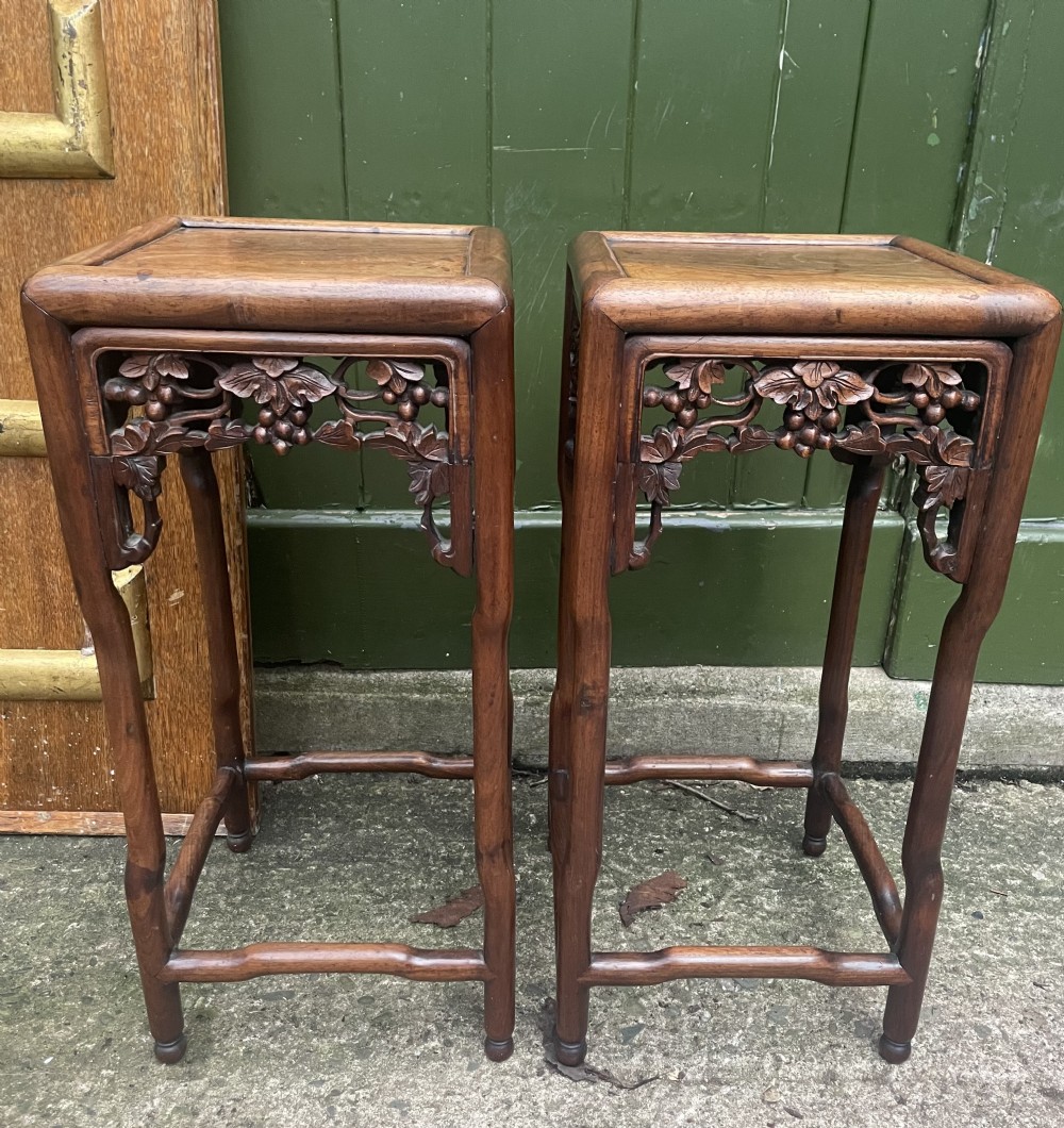 A pair of late nineteenth to early twentieth century Chinese Qing Dynasty carved huali hardwood side tables featuring openwork grapevine aprons and organic faux-bamboo legs. View XI