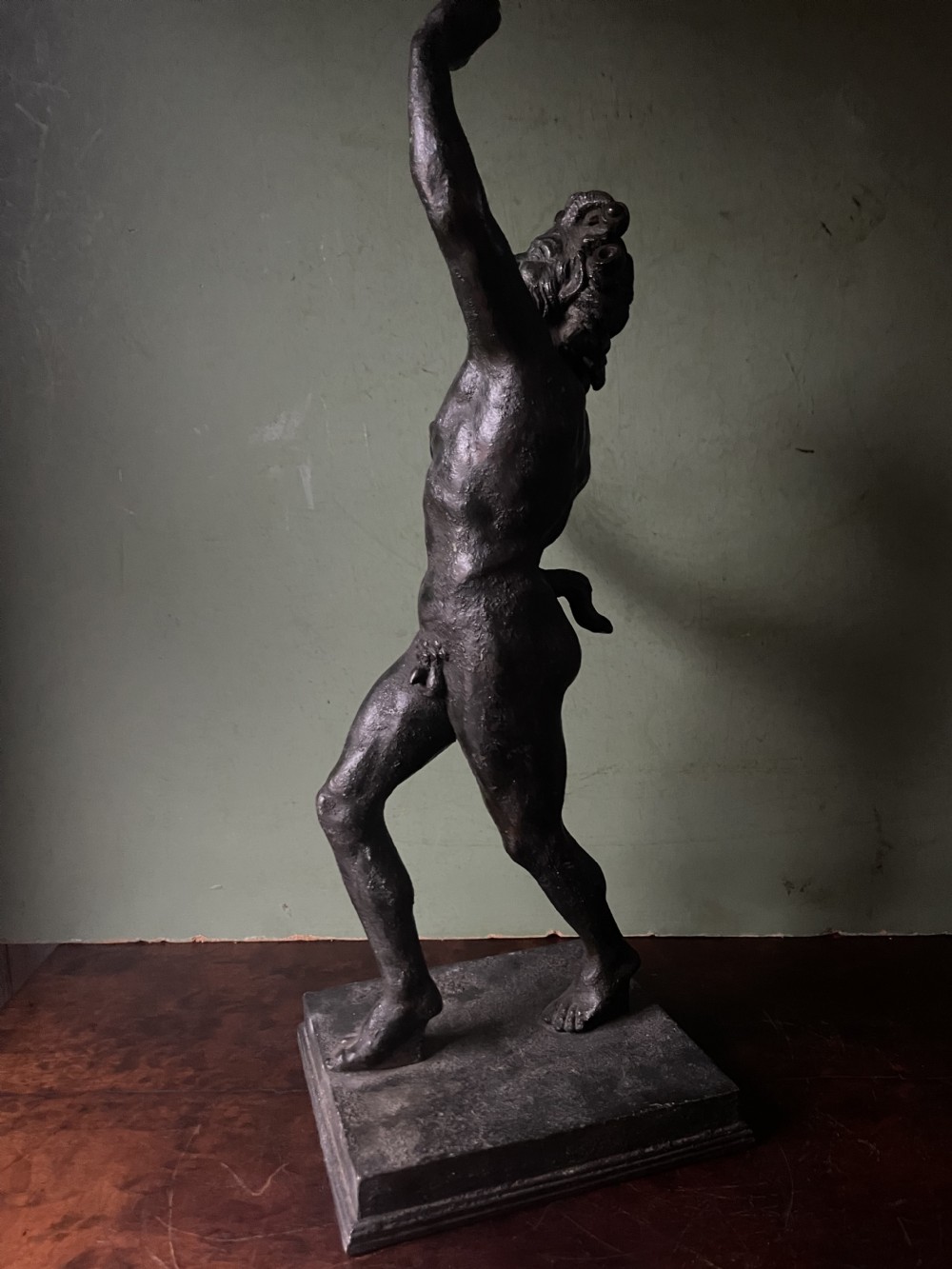 A late nineteenth-century dark patinated bronze sculpture depicting the Dancing Faun of Pompeii standing in a dynamic pose on a rectangular bronze base. View II