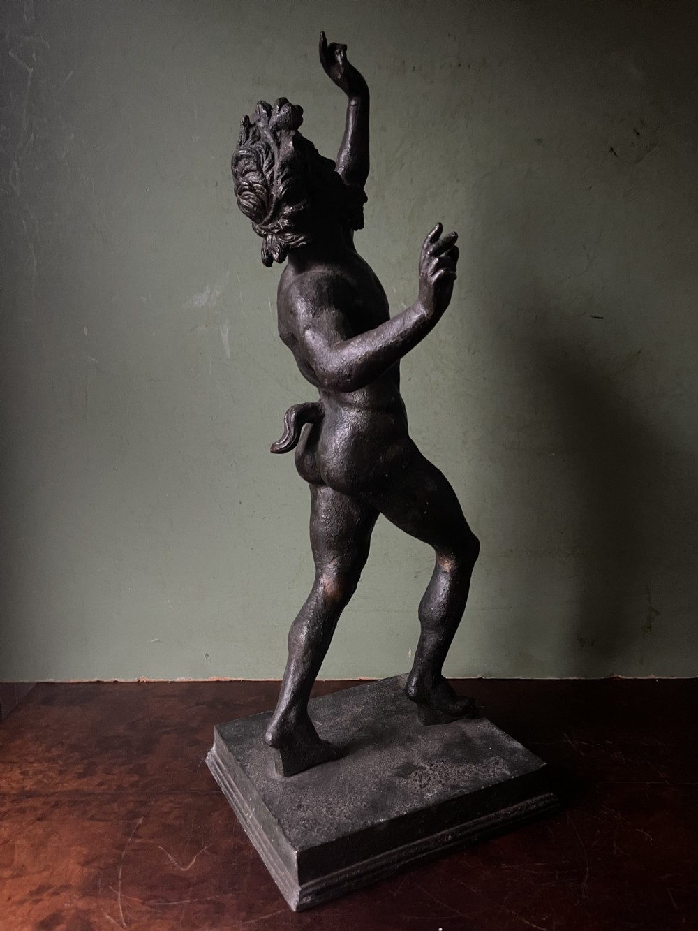 A late nineteenth-century dark patinated bronze sculpture depicting the Dancing Faun of Pompeii standing in a dynamic pose on a rectangular bronze base. View VI