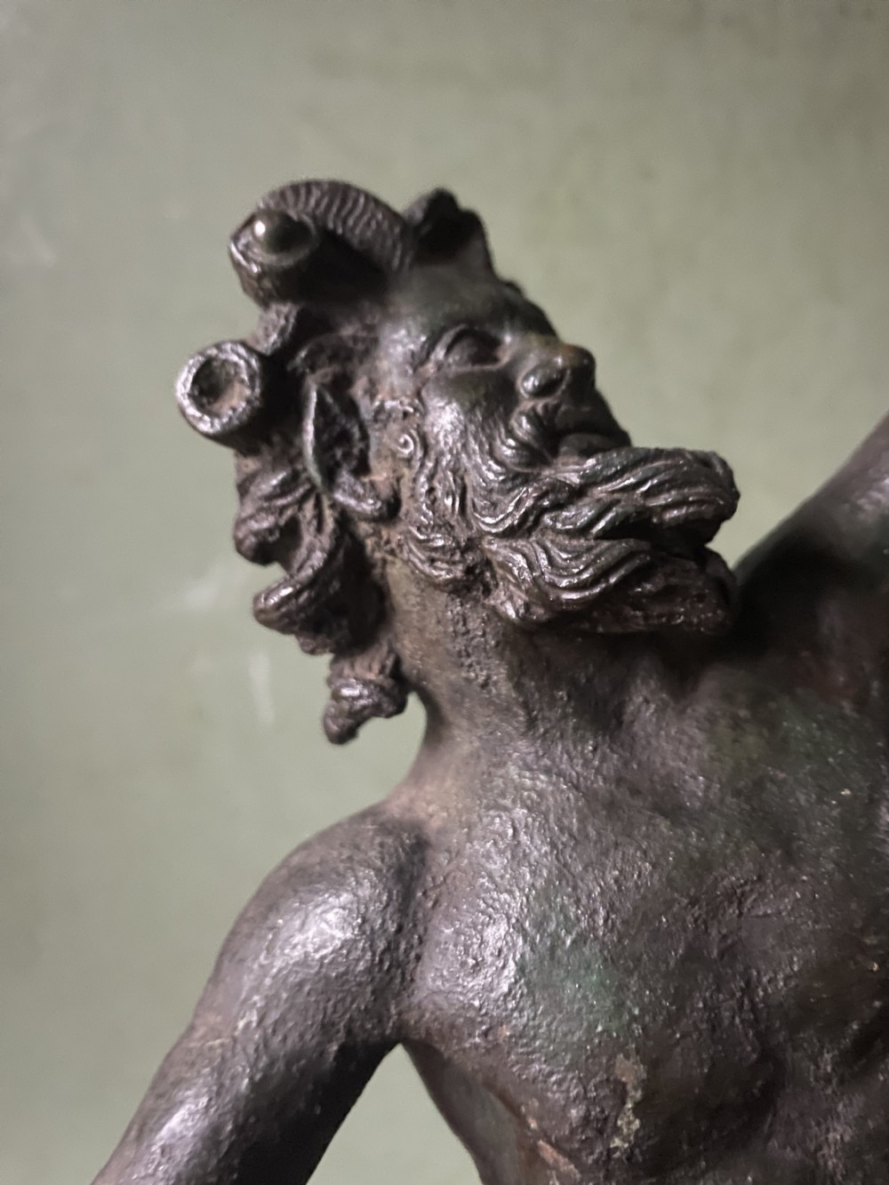 A late nineteenth-century dark patinated bronze sculpture depicting the Dancing Faun of Pompeii standing in a dynamic pose on a rectangular bronze base. View VIII
