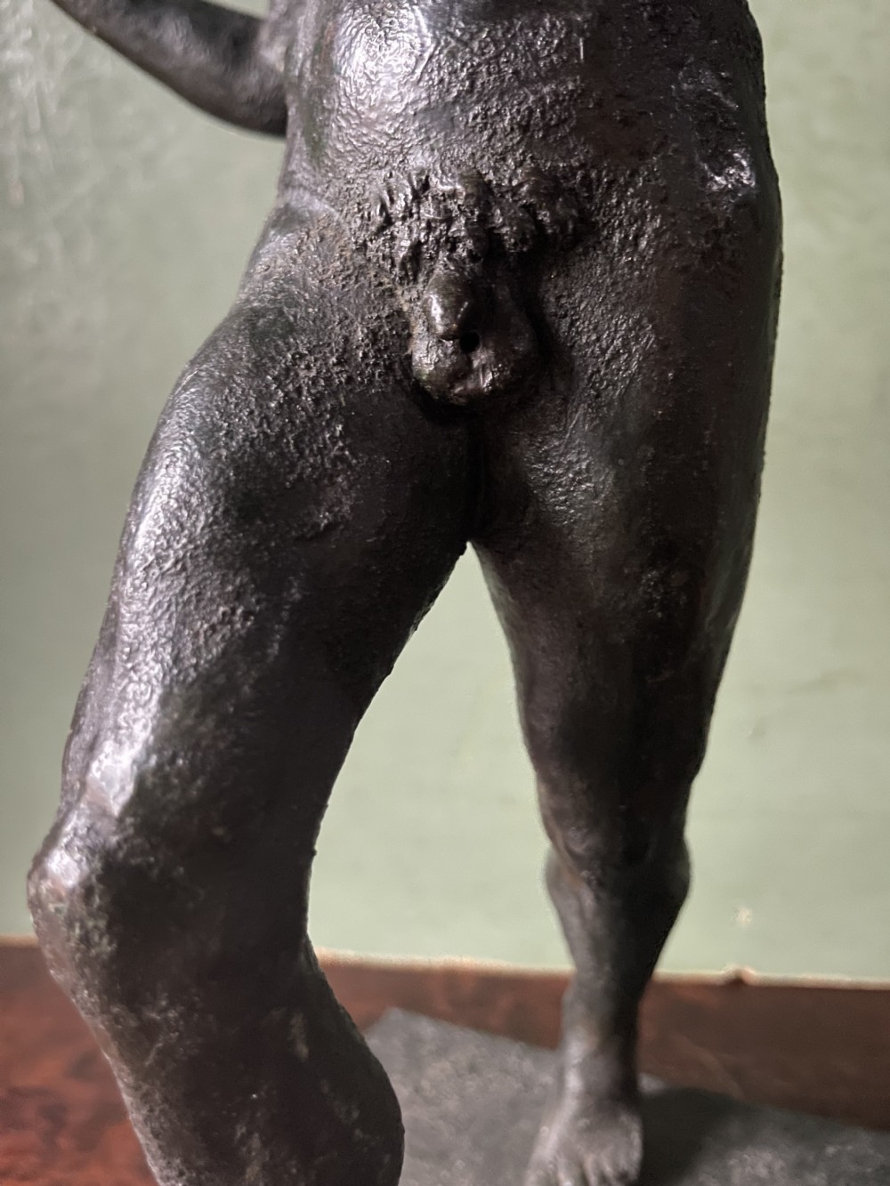 A late nineteenth-century dark patinated bronze sculpture depicting the Dancing Faun of Pompeii standing in a dynamic pose on a rectangular bronze base. View IX