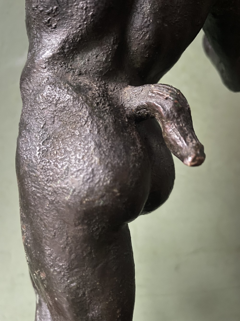 A late nineteenth-century dark patinated bronze sculpture depicting the Dancing Faun of Pompeii standing in a dynamic pose on a rectangular bronze base. View X