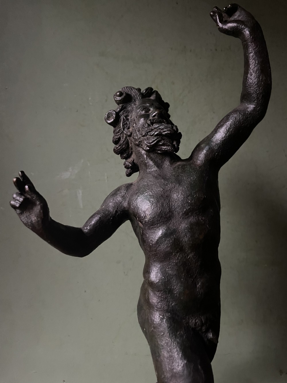 A late nineteenth-century dark patinated bronze sculpture depicting the Dancing Faun of Pompeii standing in a dynamic pose on a rectangular bronze base. View XII