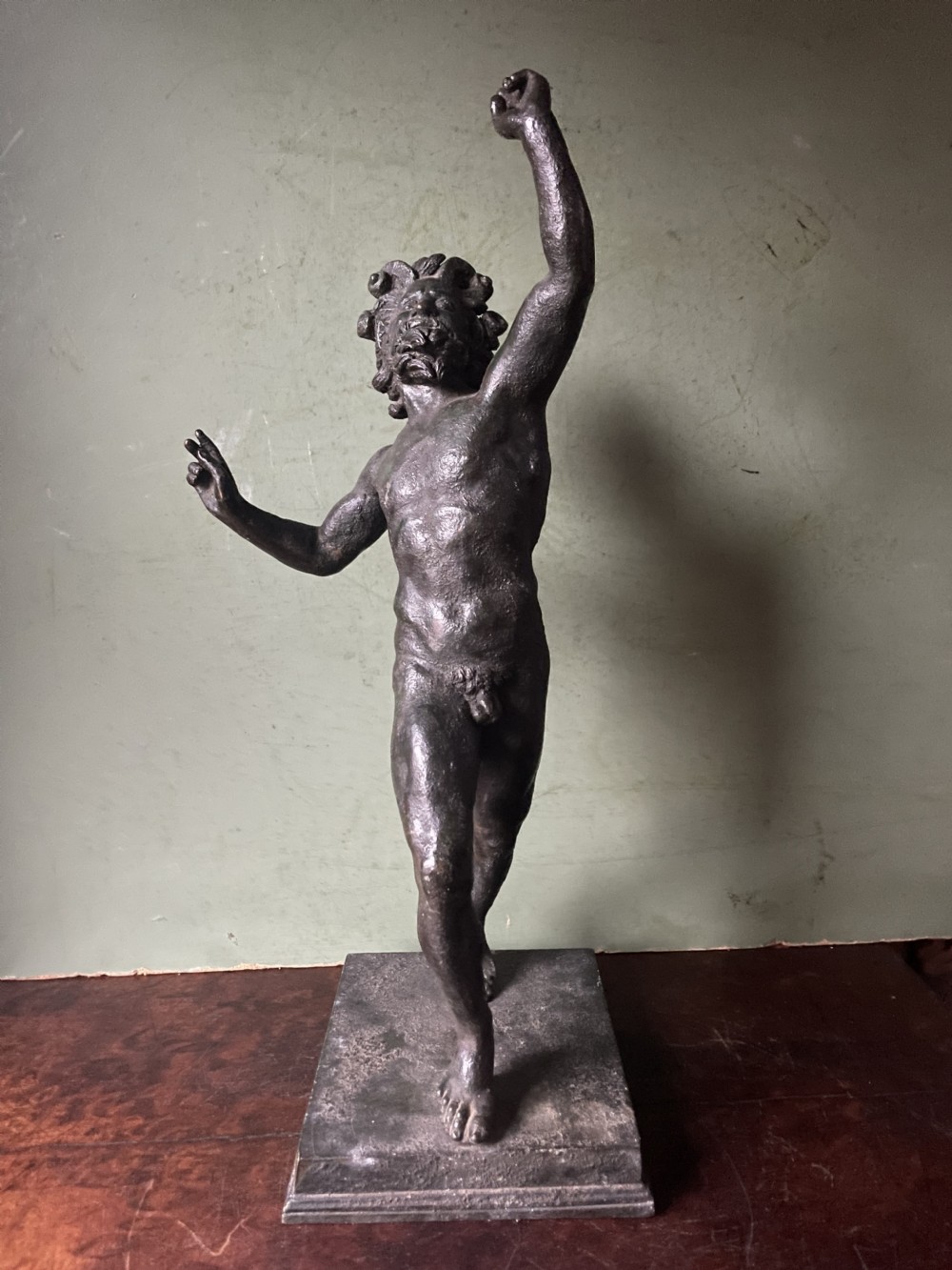 A late nineteenth-century dark patinated bronze sculpture depicting the Dancing Faun of Pompeii standing in a dynamic pose on a rectangular bronze base. View XIII