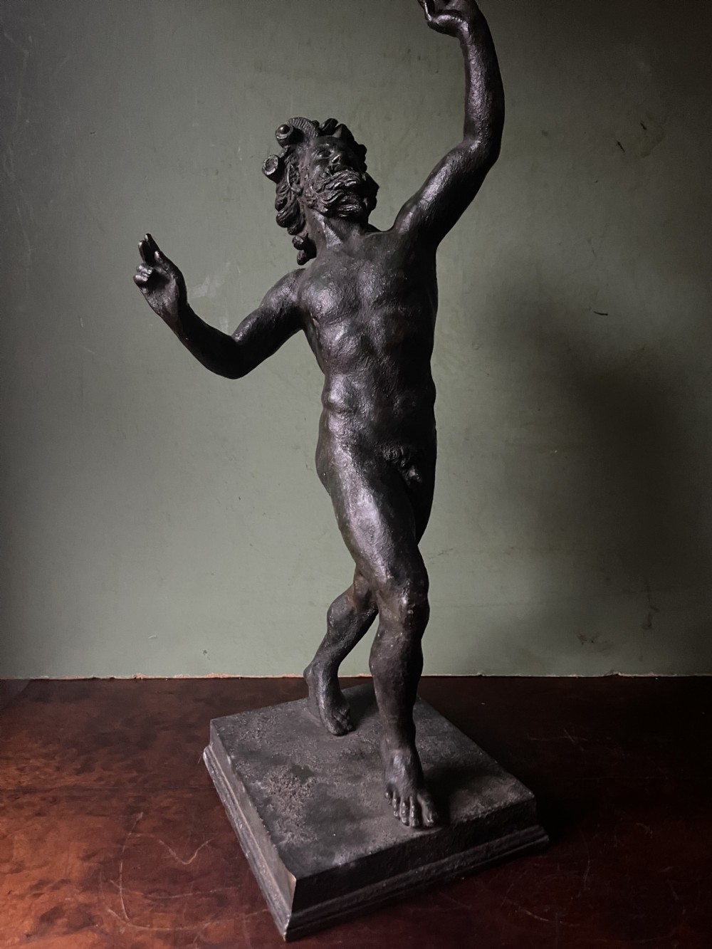 A late nineteenth-century dark patinated bronze sculpture depicting the Dancing Faun of Pompeii standing in a dynamic pose on a rectangular bronze base. View XIV