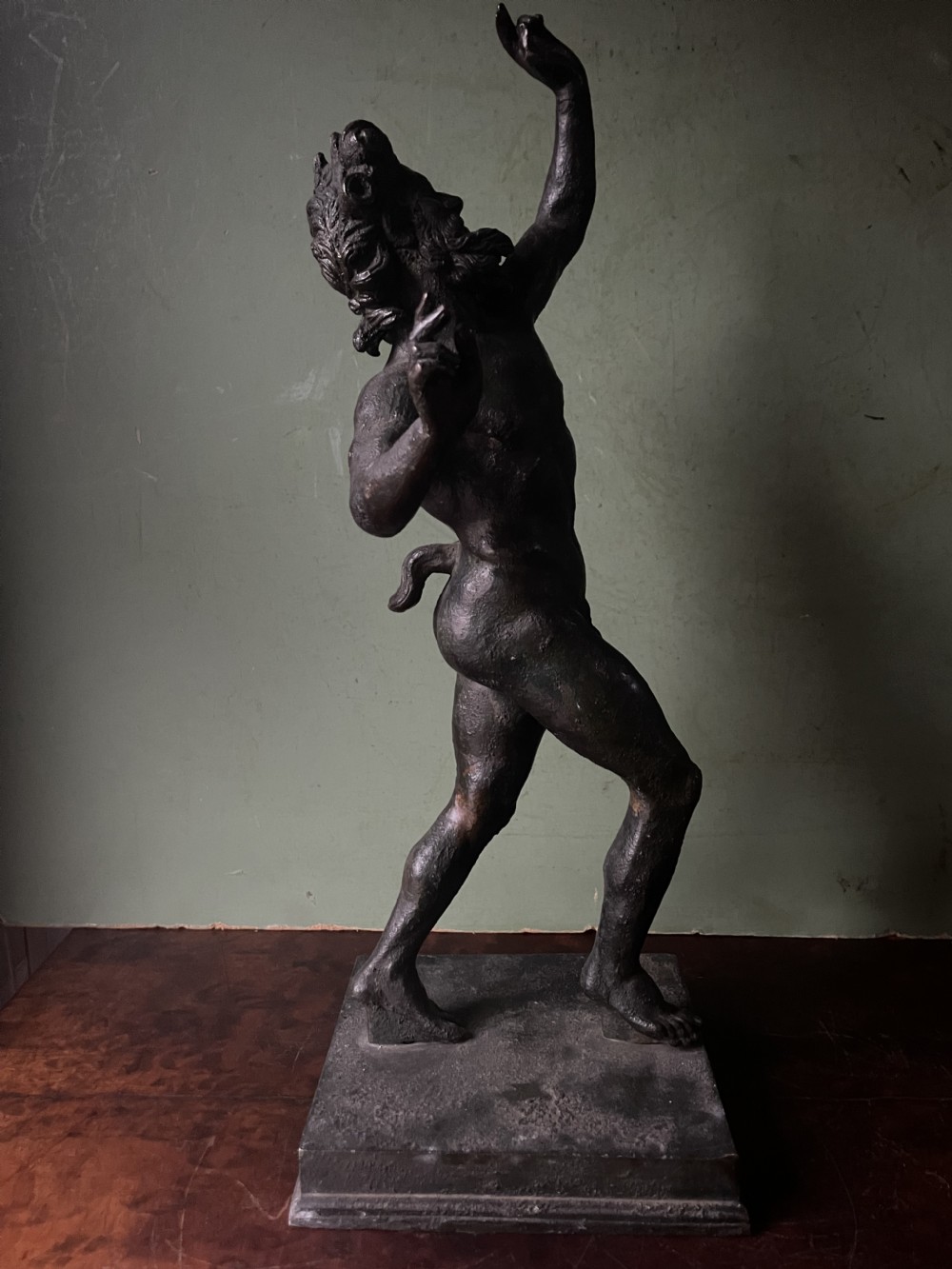 A late nineteenth-century dark patinated bronze sculpture depicting the Dancing Faun of Pompeii standing in a dynamic pose on a rectangular bronze base. View XVI