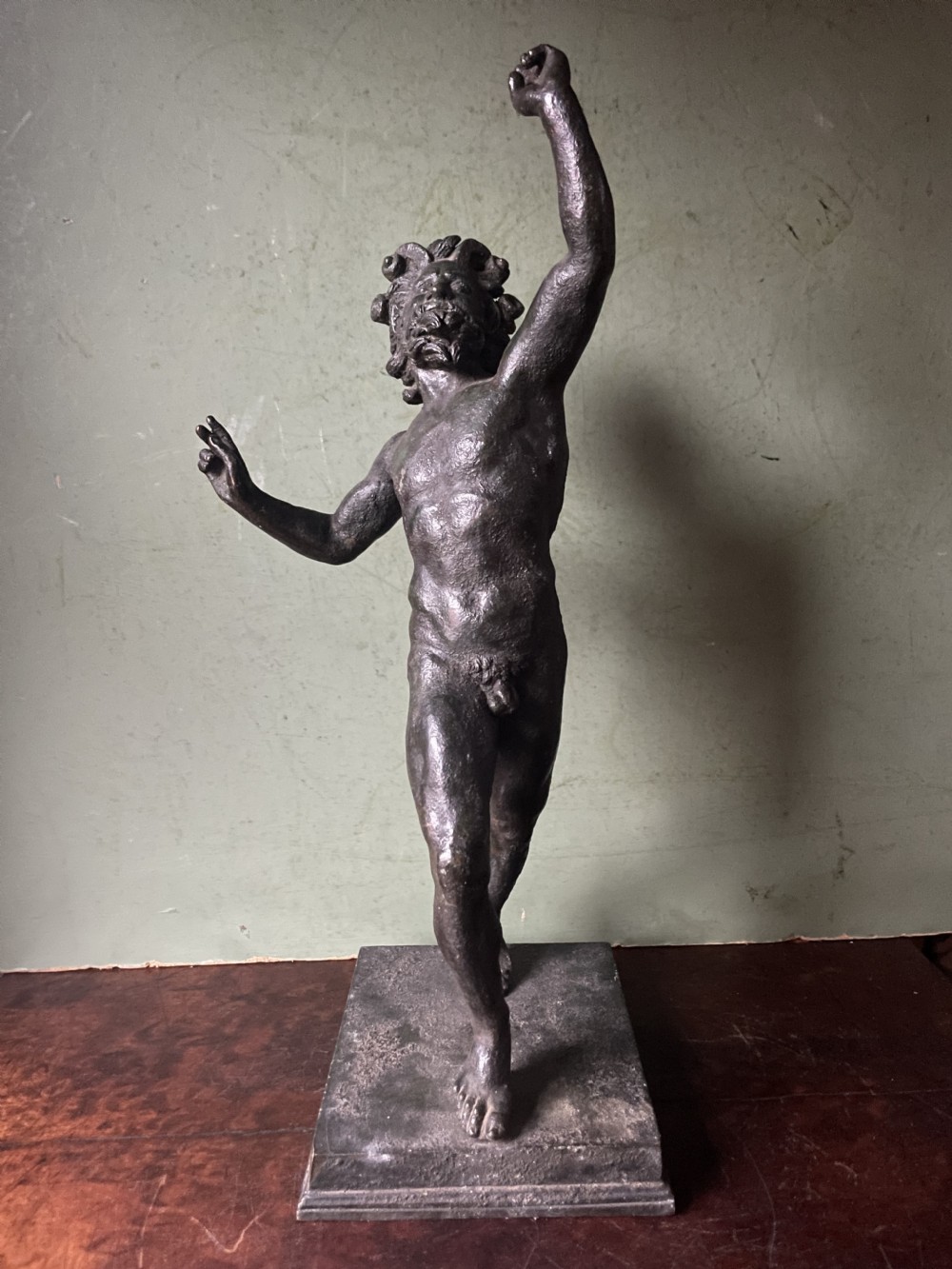A late nineteenth-century dark patinated bronze sculpture depicting the Dancing Faun of Pompeii standing in a dynamic pose on a rectangular bronze base. View VII