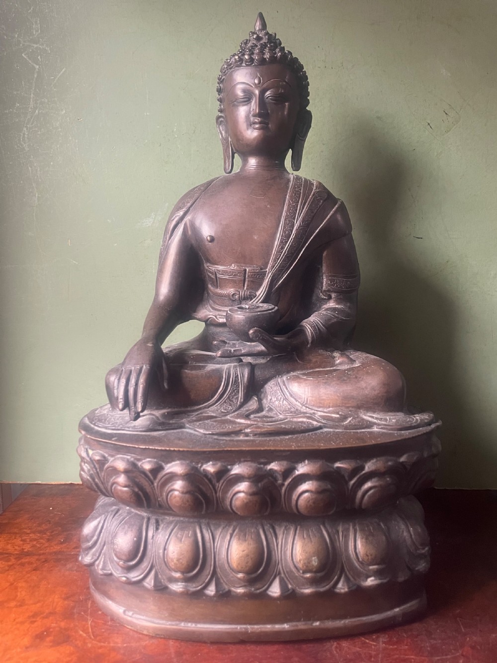 A 19th-century Sino-Tibetan style dark bronze sculpture of Buddha Shakyamuni seated on a lotus pedestal. View II