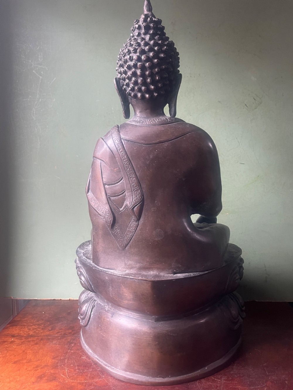 A 19th-century Sino-Tibetan style dark bronze sculpture of Buddha Shakyamuni seated on a lotus pedestal. View IV