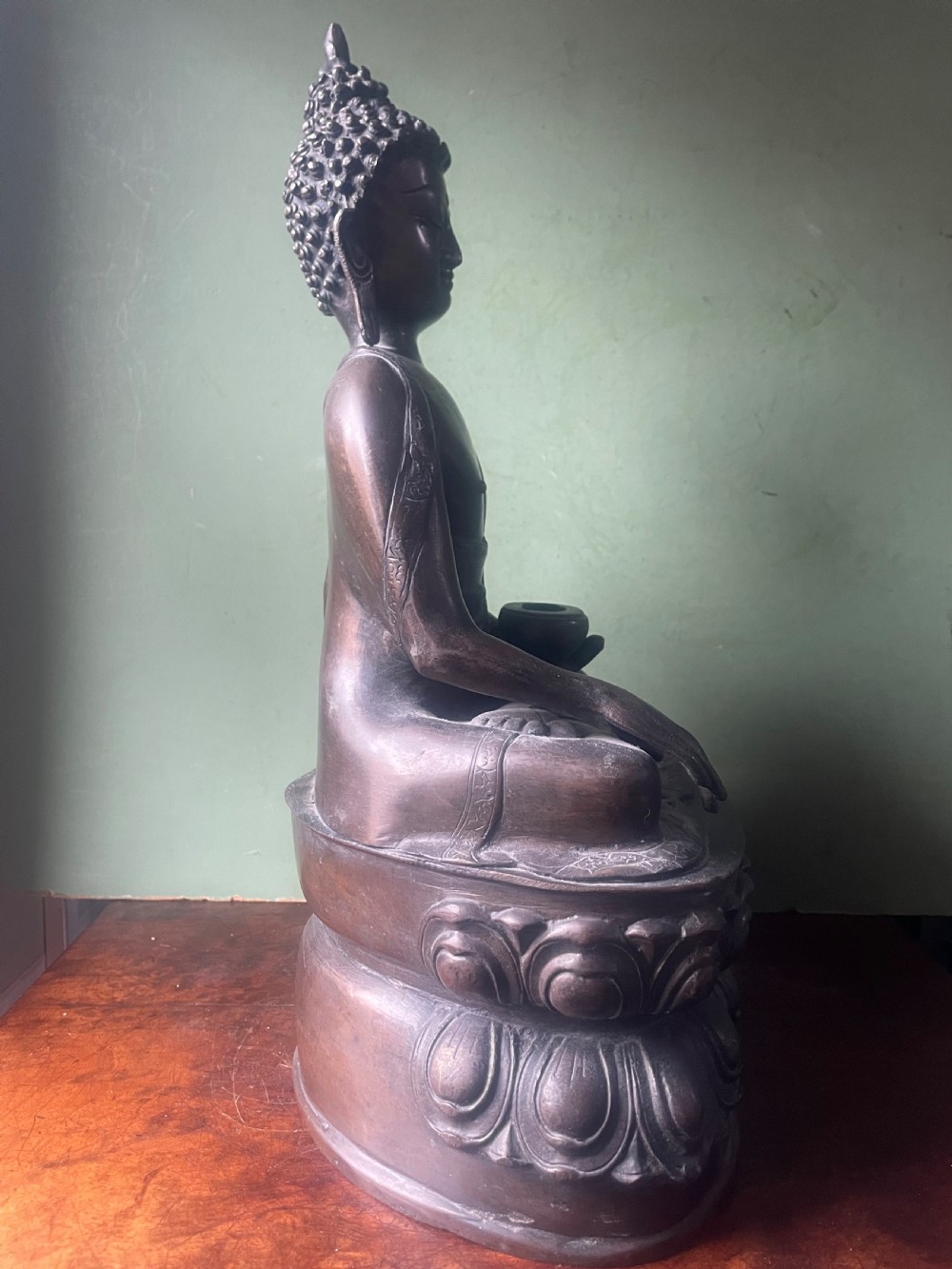 A 19th-century Sino-Tibetan style dark bronze sculpture of Buddha Shakyamuni seated on a lotus pedestal. View VI