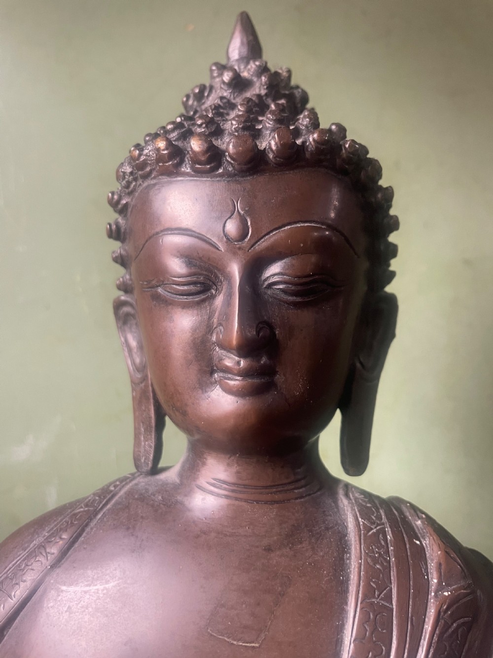 A 19th-century Sino-Tibetan style dark bronze sculpture of Buddha Shakyamuni seated on a lotus pedestal. View VII