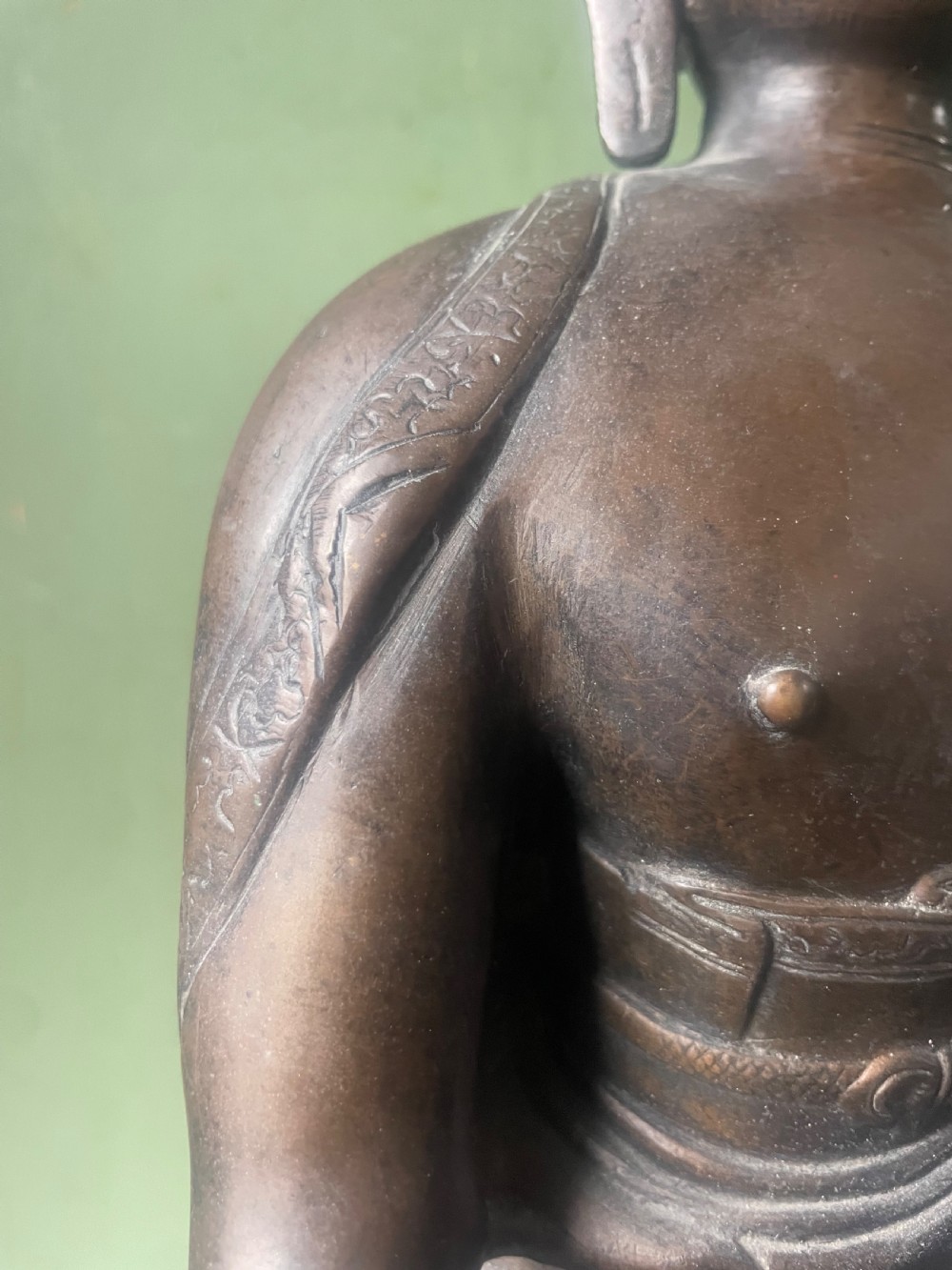 A 19th-century Sino-Tibetan style dark bronze sculpture of Buddha Shakyamuni seated on a lotus pedestal. View XI