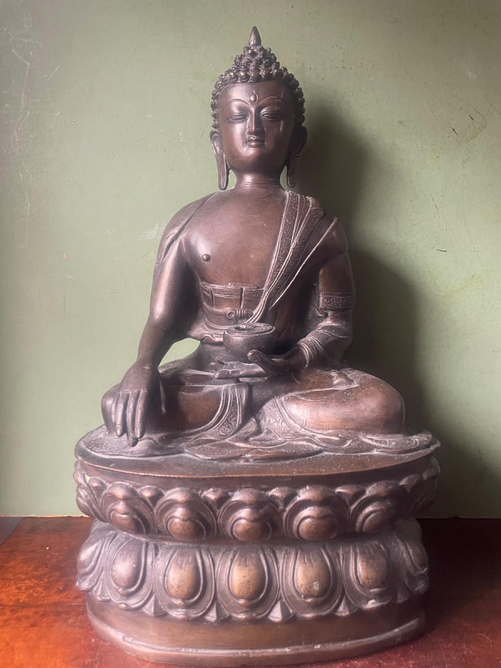 A 19th-century Sino-Tibetan style dark bronze sculpture of Buddha Shakyamuni seated on a lotus pedestal. View XIII