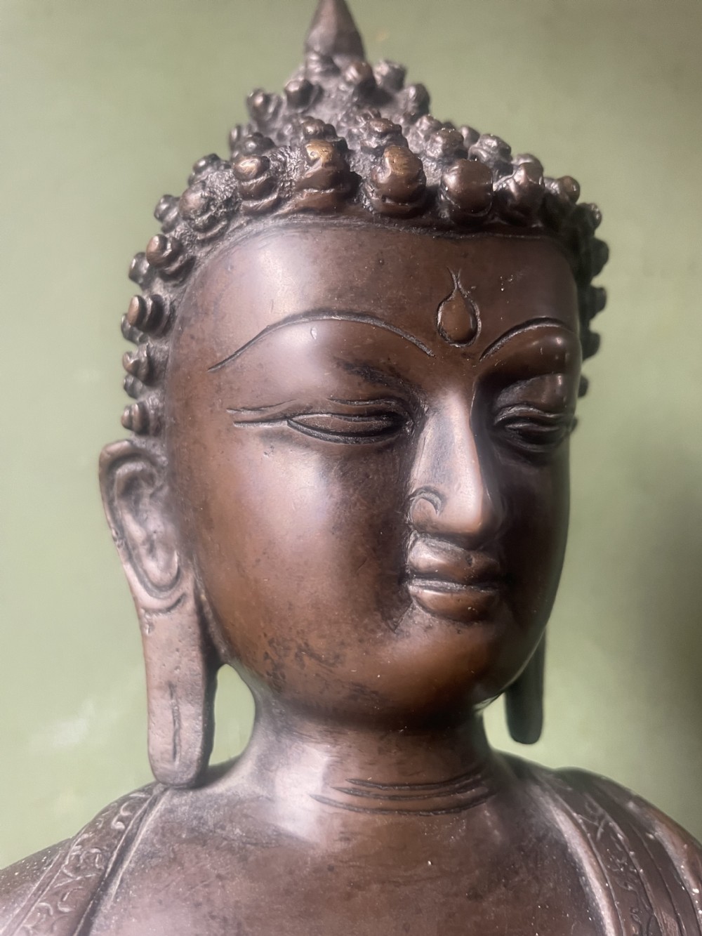 A 19th-century Sino-Tibetan style dark bronze sculpture of Buddha Shakyamuni seated on a lotus pedestal. View XV