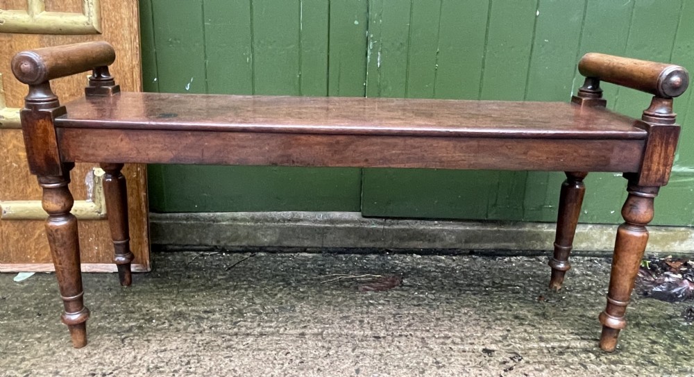 Early C19th Regency period mahogany hall bench or seat with cylindrical roll-end supports.