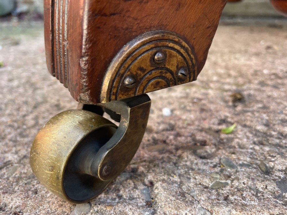 A late nineteenth-century octagonal walnut library table featuring a tooled dark leather inset top, turned legs, a cross stretcher, and brass castors. View VIII