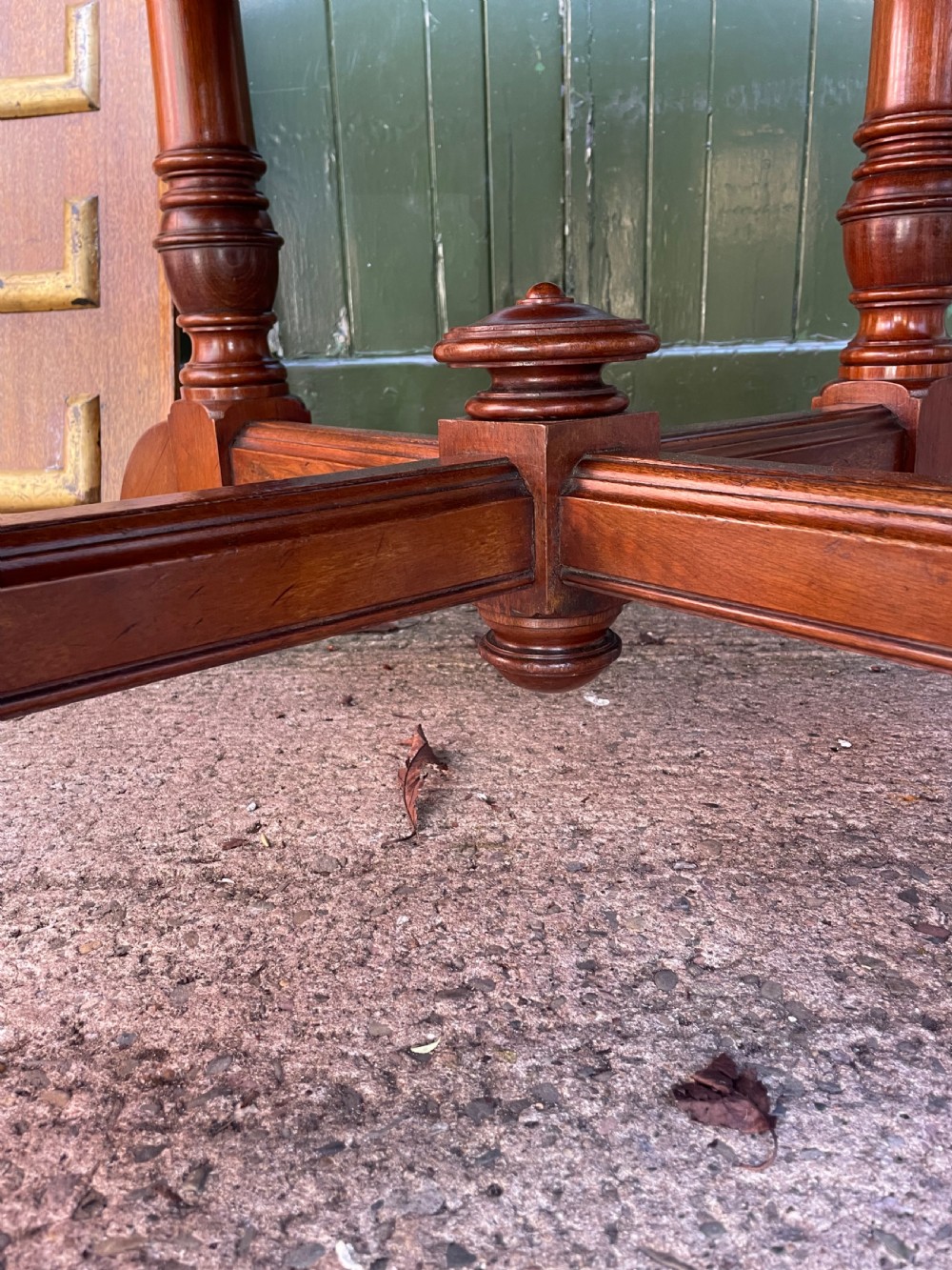 A late nineteenth-century octagonal walnut library table featuring a tooled dark leather inset top, turned legs, a cross stretcher, and brass castors. View IX