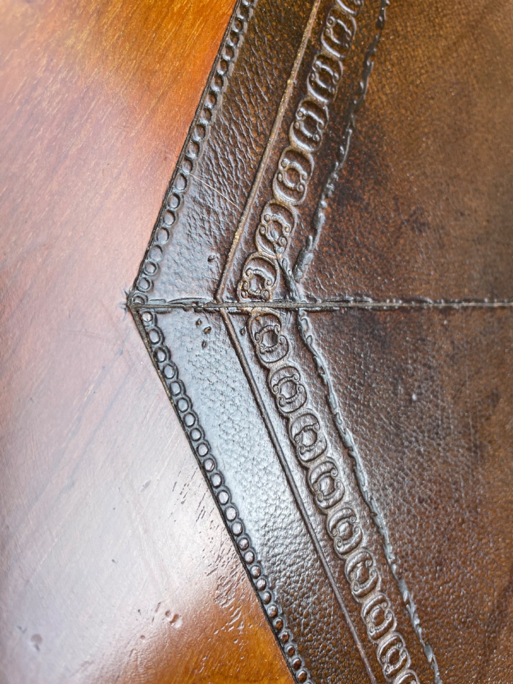 A late nineteenth-century octagonal walnut library table featuring a tooled dark leather inset top, turned legs, a cross stretcher, and brass castors. View XI