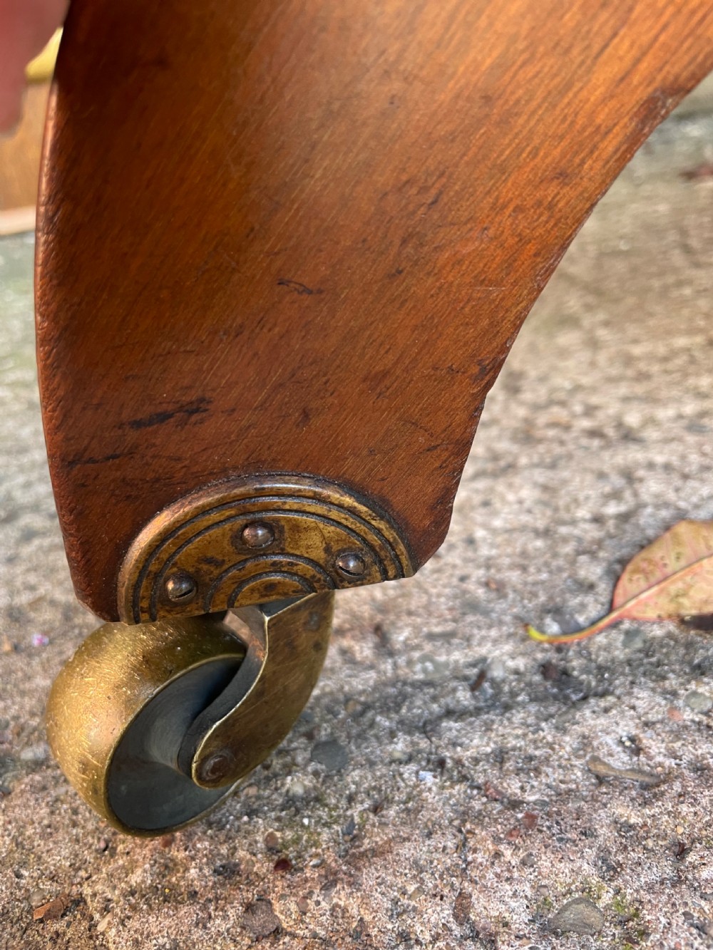 A late nineteenth-century octagonal walnut library table featuring a tooled dark leather inset top, turned legs, a cross stretcher, and brass castors. View XX