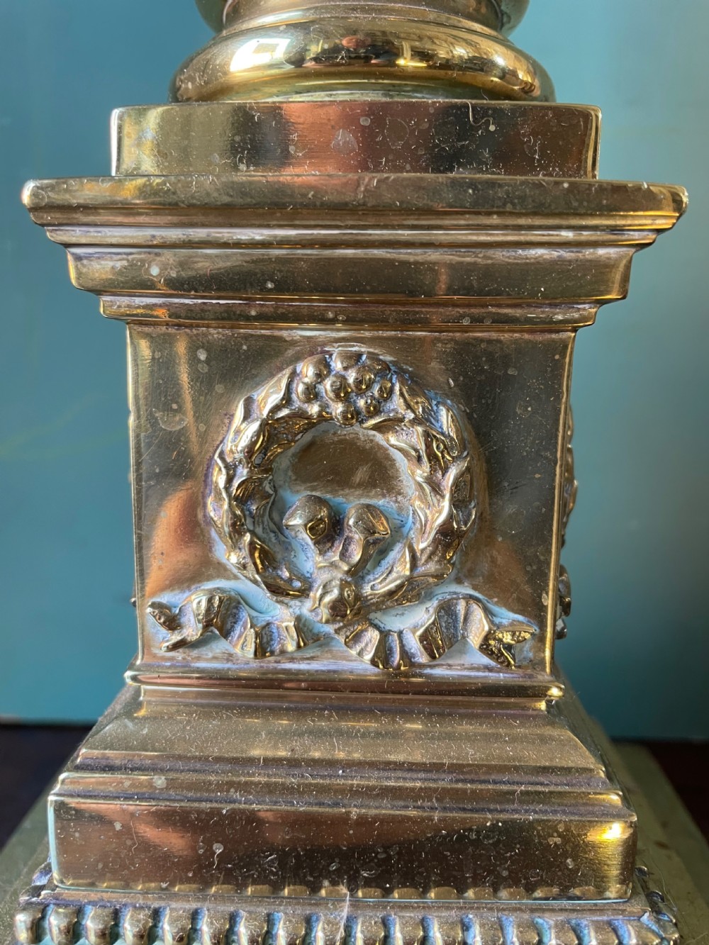A late 19th-century brass table lamp styled as a classical fluted column with a stepped base and laurel wreath detail. View VII