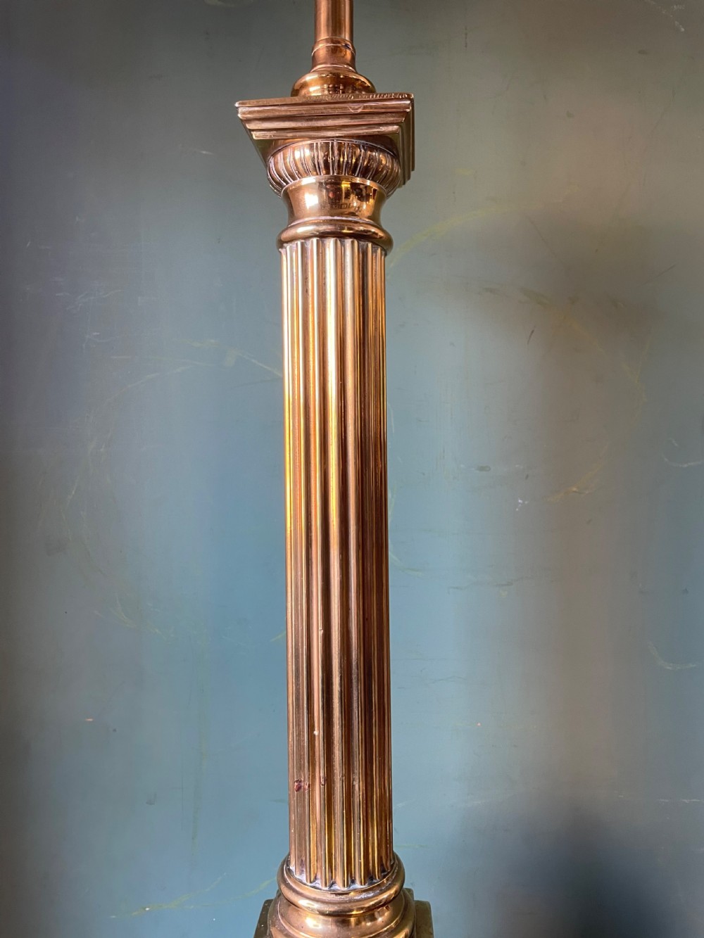 A late 19th-century brass table lamp styled as a classical fluted column with a stepped base and laurel wreath detail. View XI
