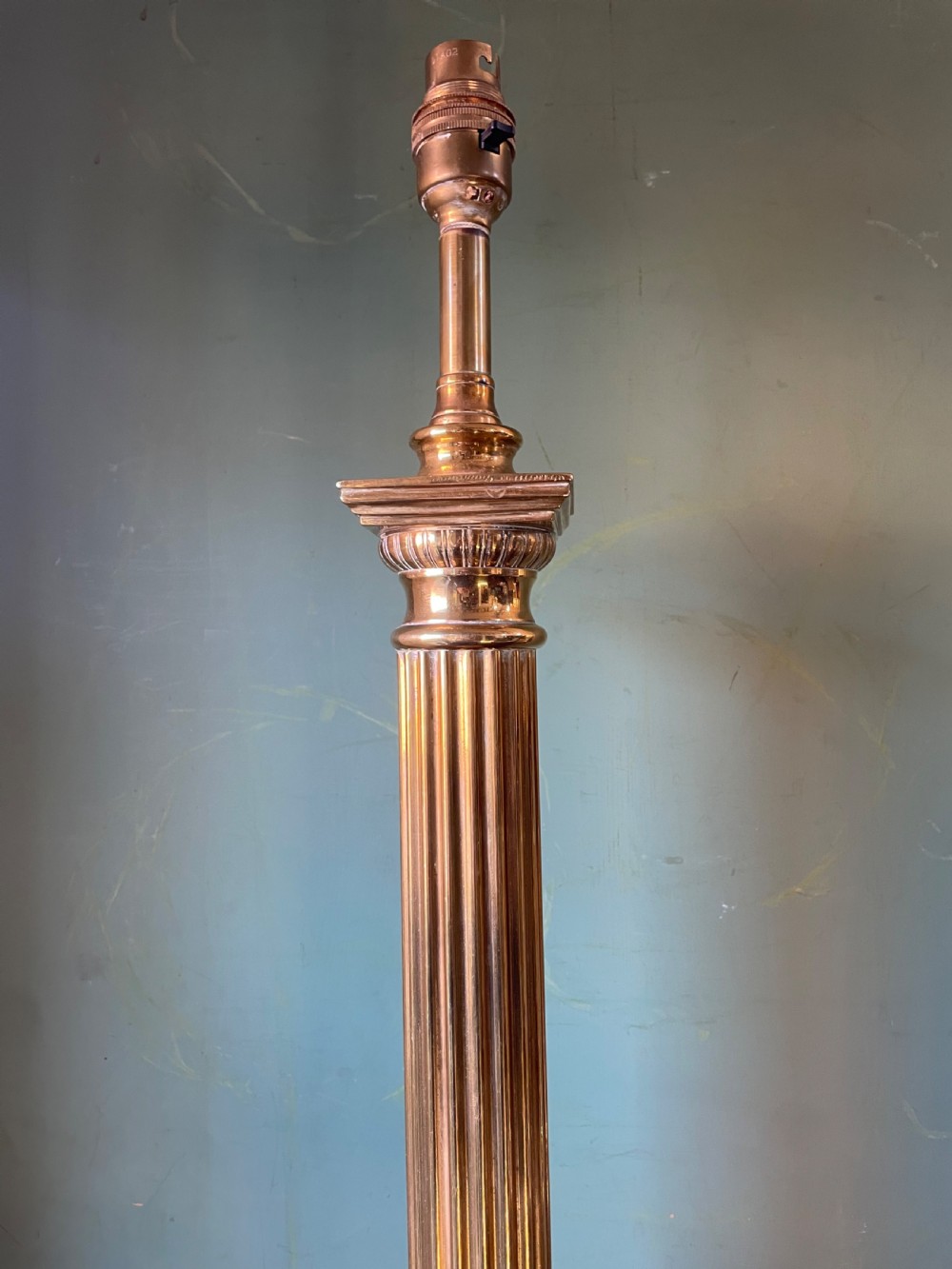 A late 19th-century brass table lamp styled as a classical fluted column with a stepped base and laurel wreath detail. View XII